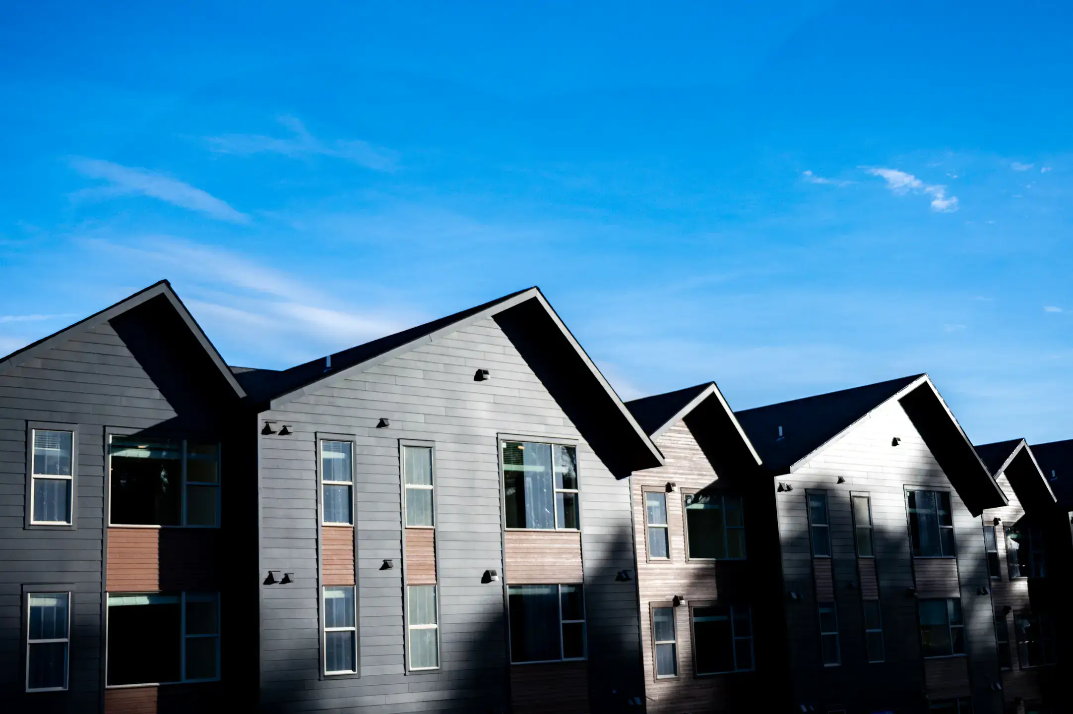 New apartment complexes with a modern black and wood design.