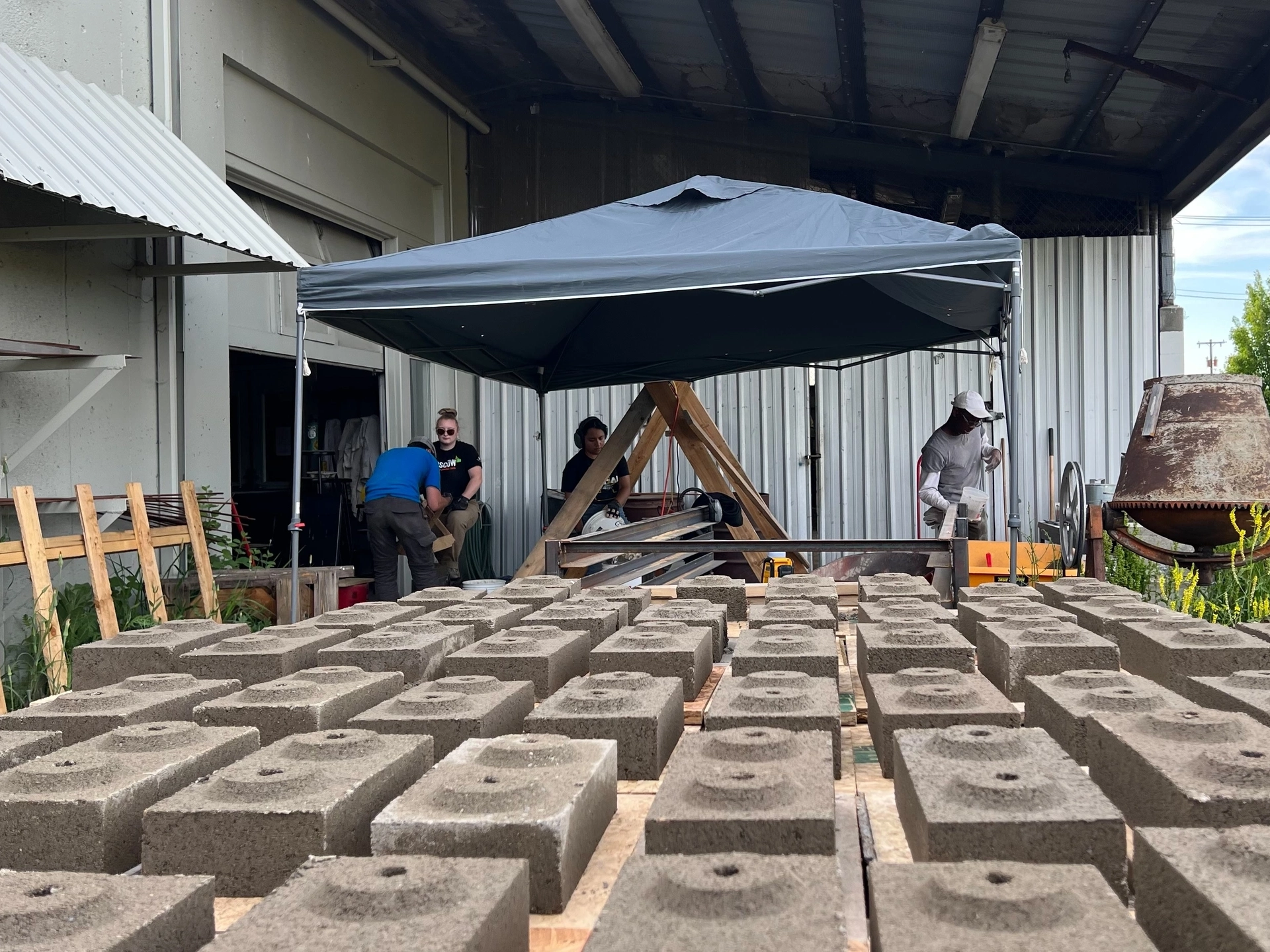 Bricks laying on a table in front of pop-up tent