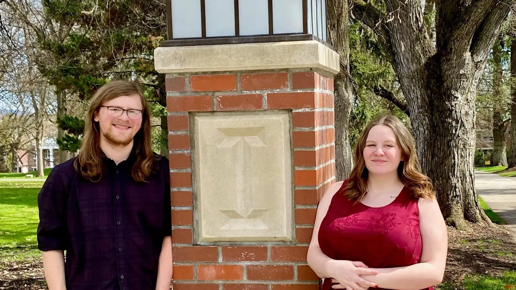 Carson McKenzie and MacKara McKenzie pose by an "I" pillar along Hello Walk. 