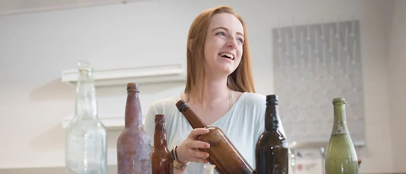 Woman holds old bottle