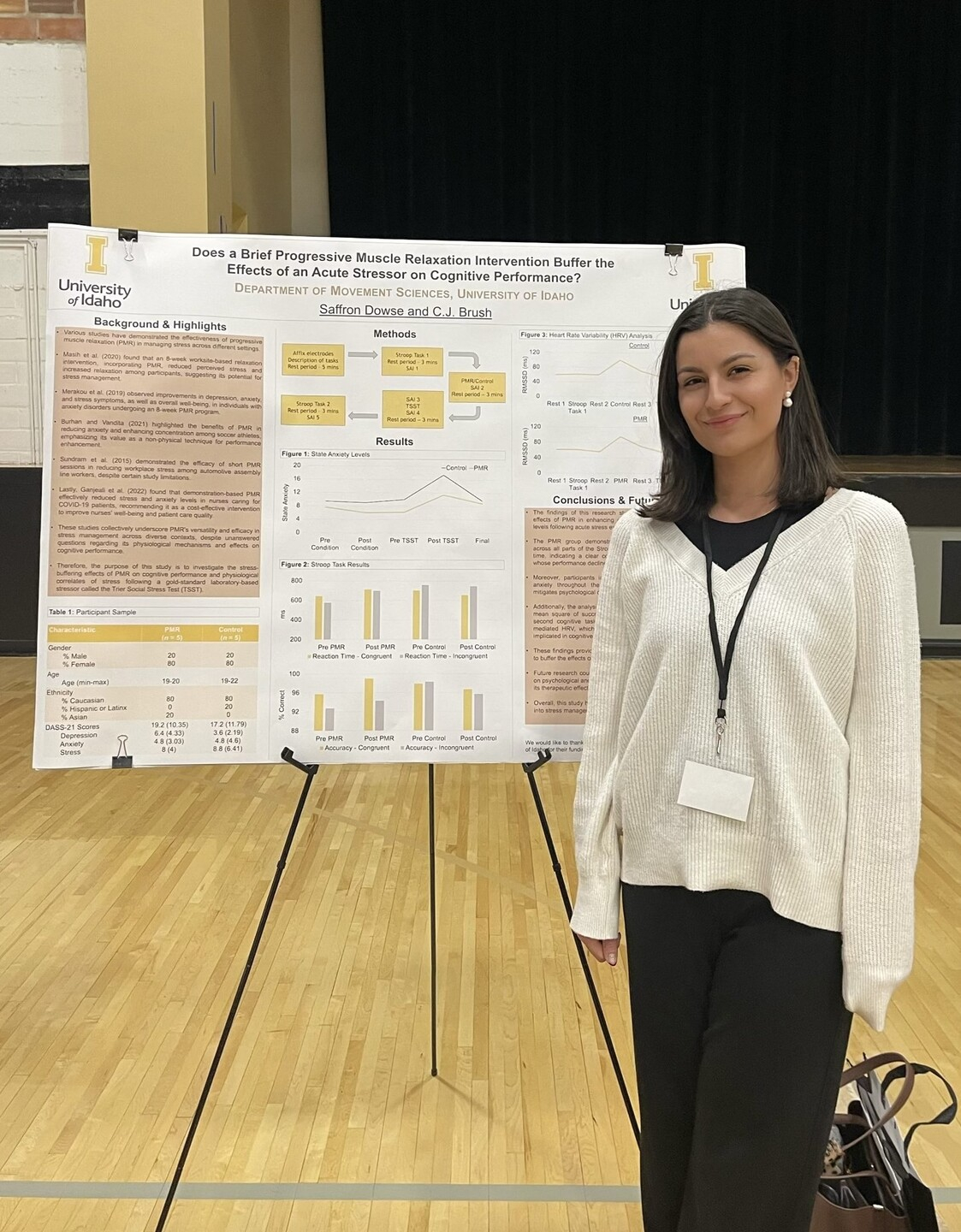 Saffron Dowse standing next to a presentation poster.
