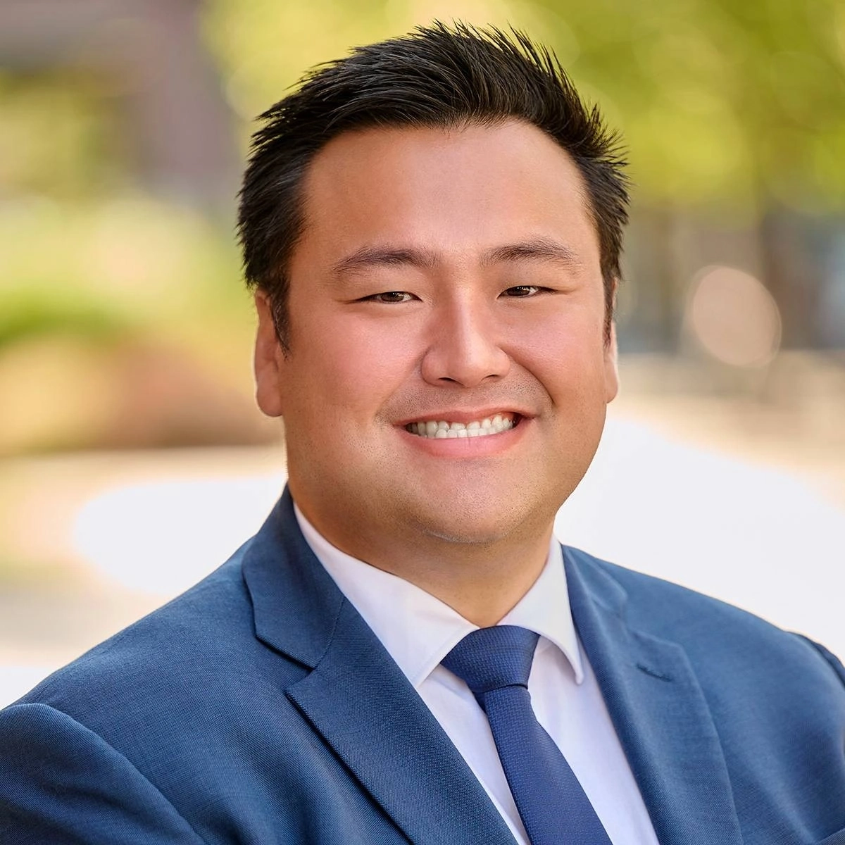 A headshot of a man in a suit