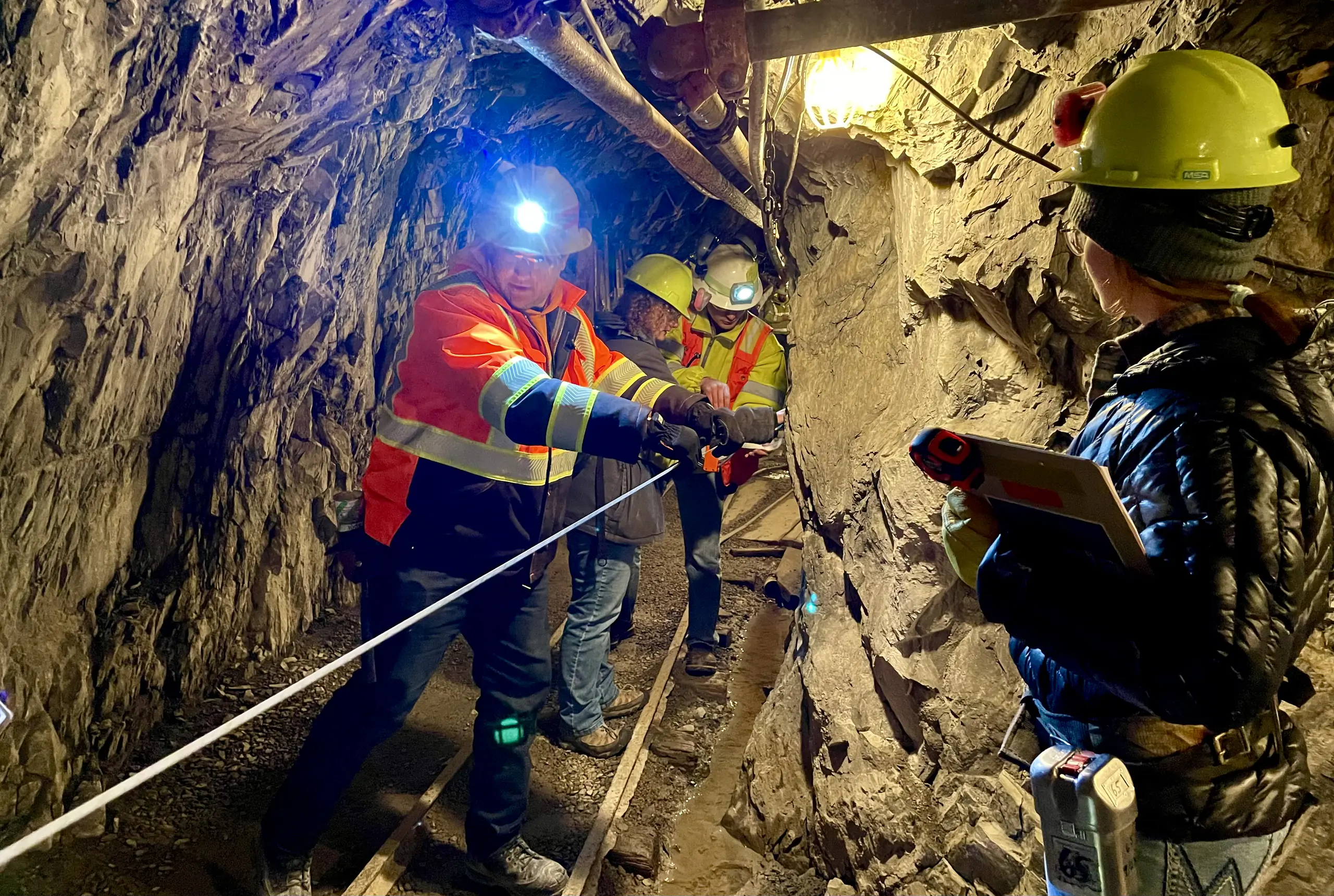 People working in an underground tunnel.