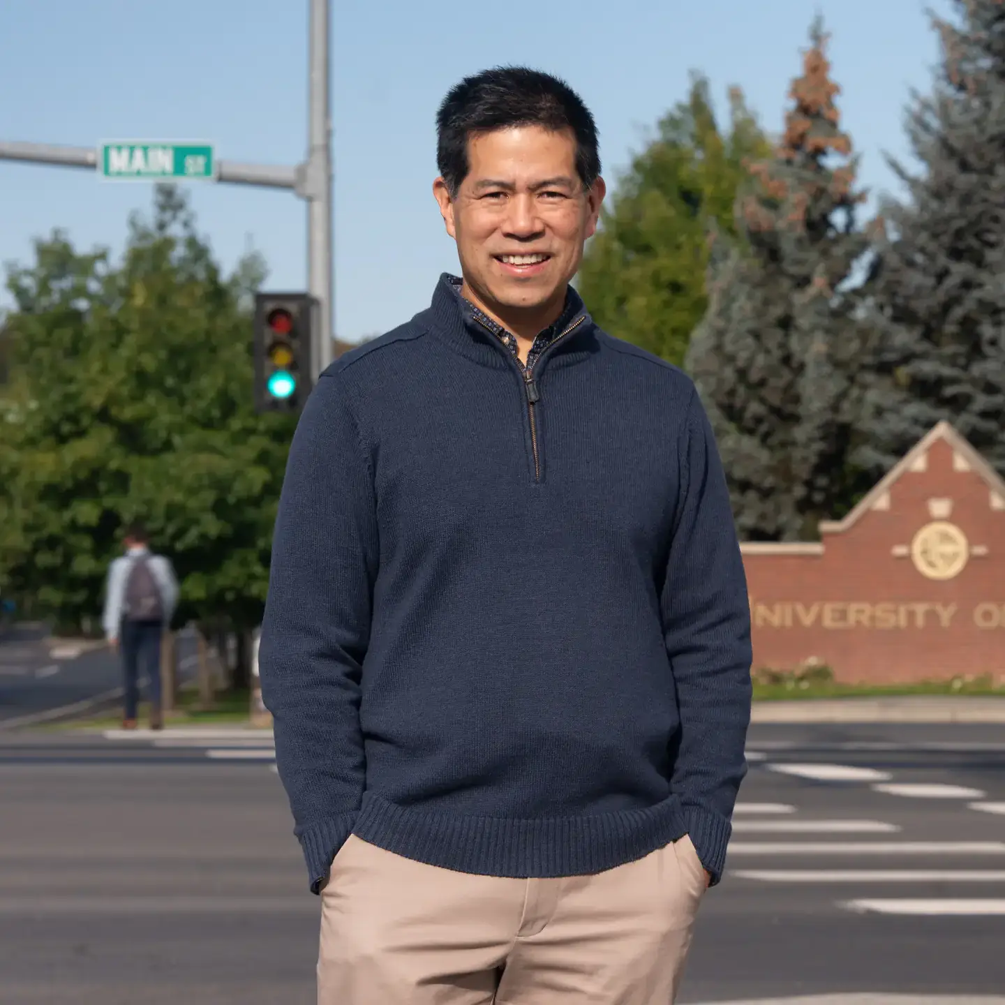 A man standing in front of a street.