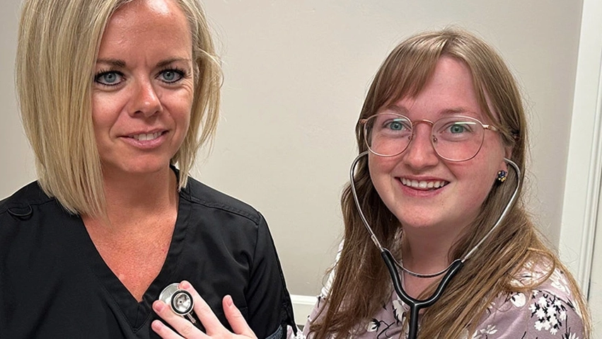 A medical student practices using a stethoscope