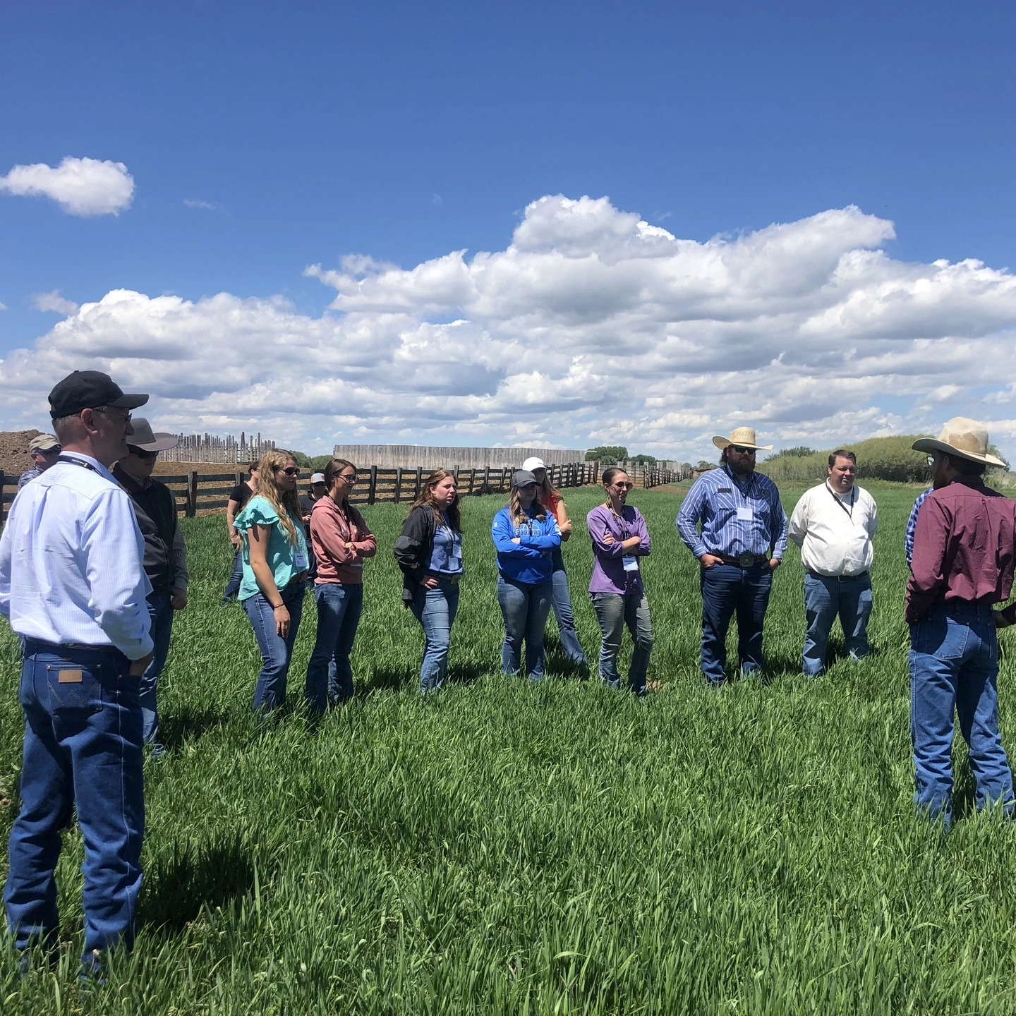 A group stands in a field.