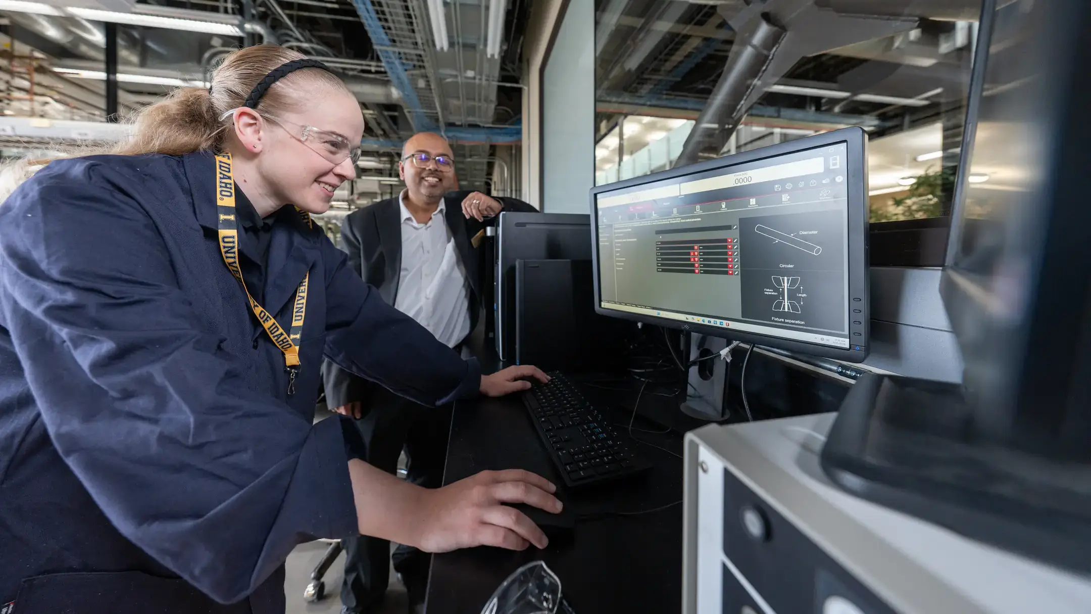 A student measures mechanical stress on materials using a computer.