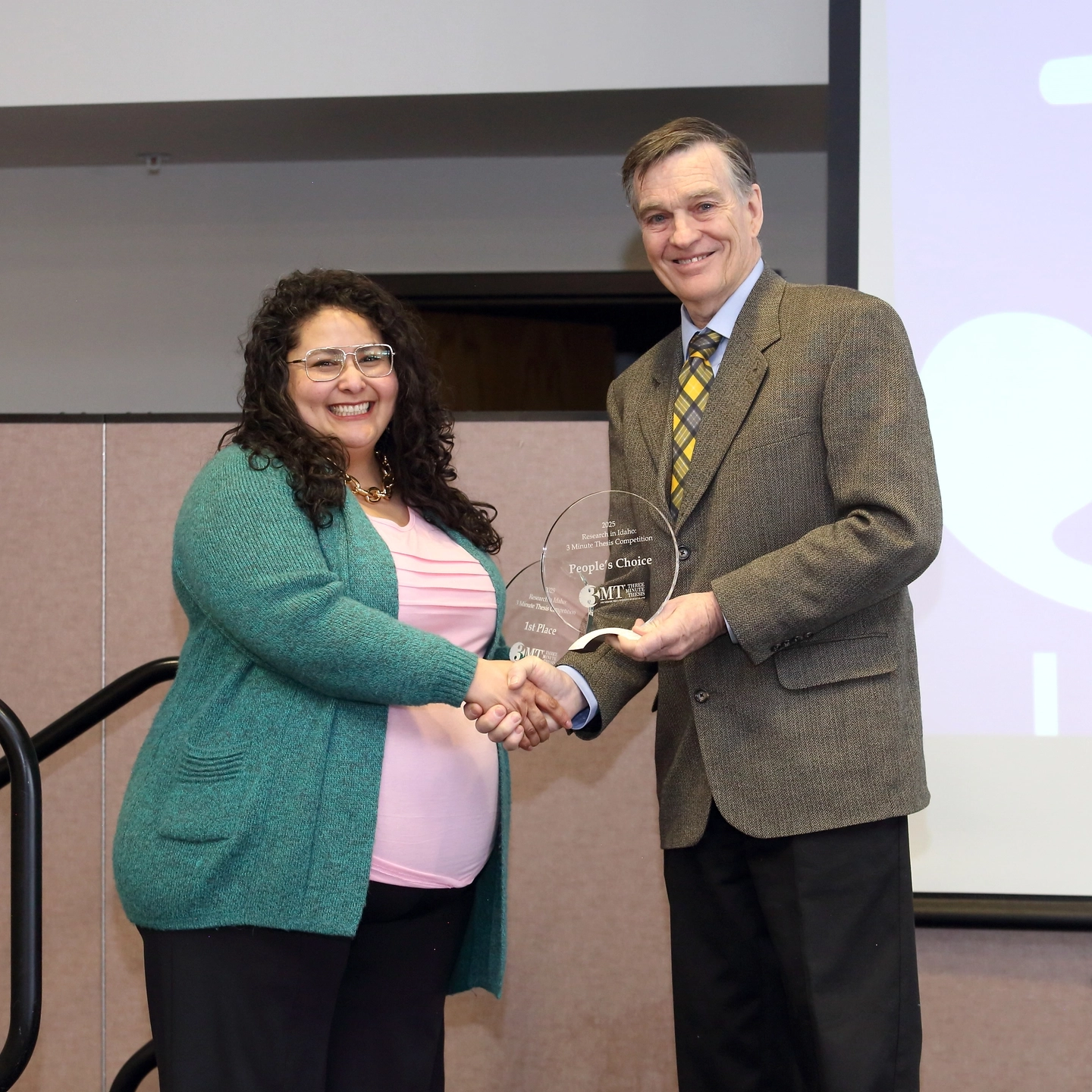 The Three Minute Thesis (3MT) 2025 Statewide Ӱֱ Competition is held in the Bennion Student Union Building at the Ӱֱ - Idaho Falls campus on Tuesday, February 11, 2025.

Graduate students from Ӱֱ, Boise State University and Idaho State University compete annually in the 3MT statewide competition and present their research in just three minutes or less with only one slide. A panel of judges choose 1st, 2nd, and 3rd place, and the audience gets the chance to vote for the People's Choice Award.

Rita Franco is awarded 2nd Place and the People’s Choice Award for her thesis “Improving Child Nutrition Through Household Poultry Projects in Guatemala”.