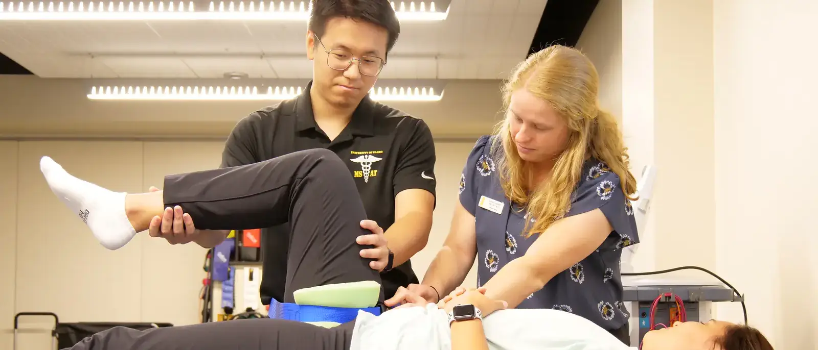 Three students partaking in athletic training practices.