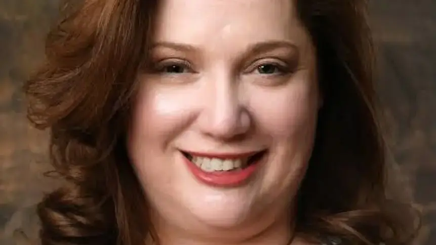 A woman with brown hair smiling