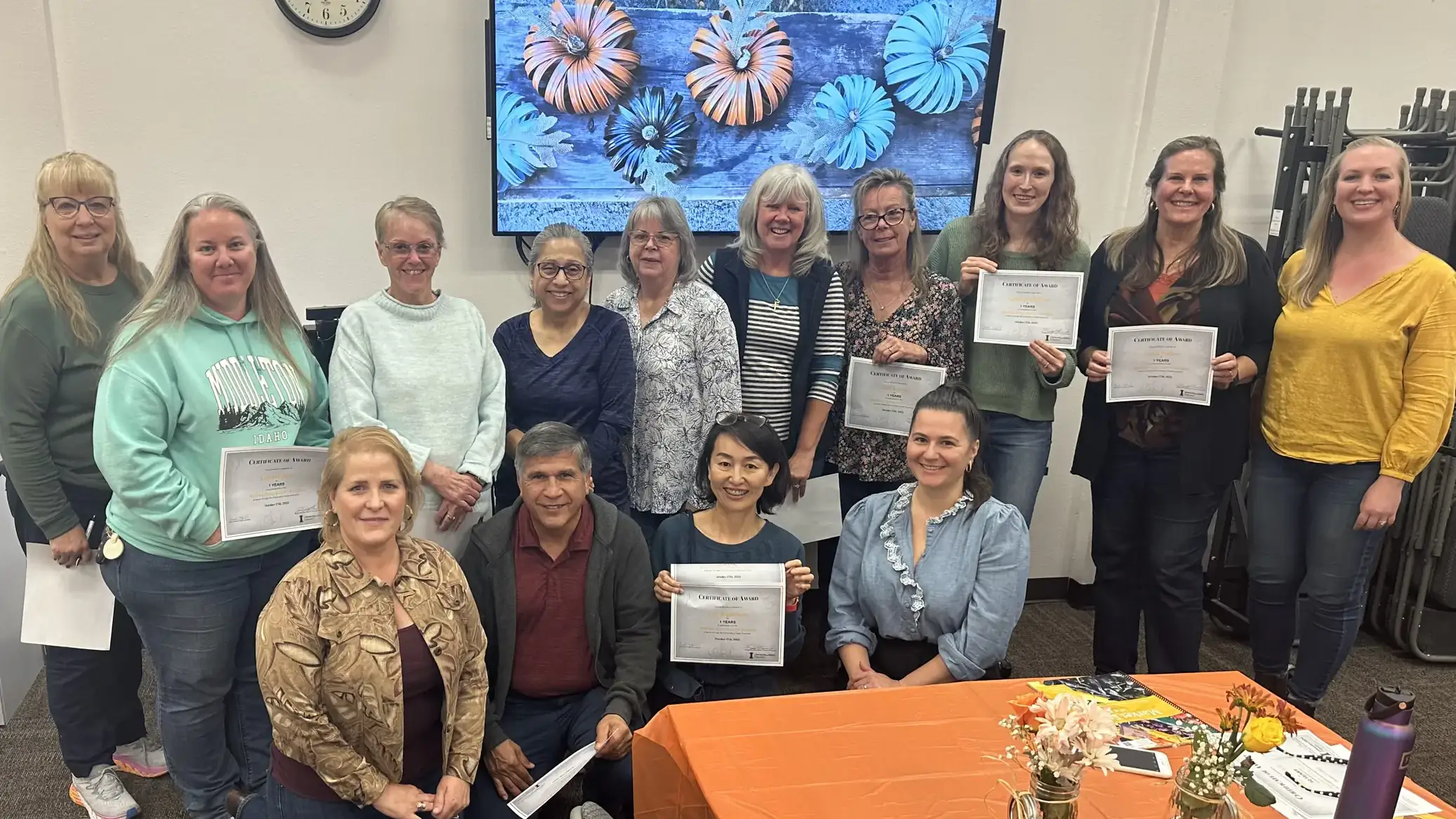A group holding a certificate.