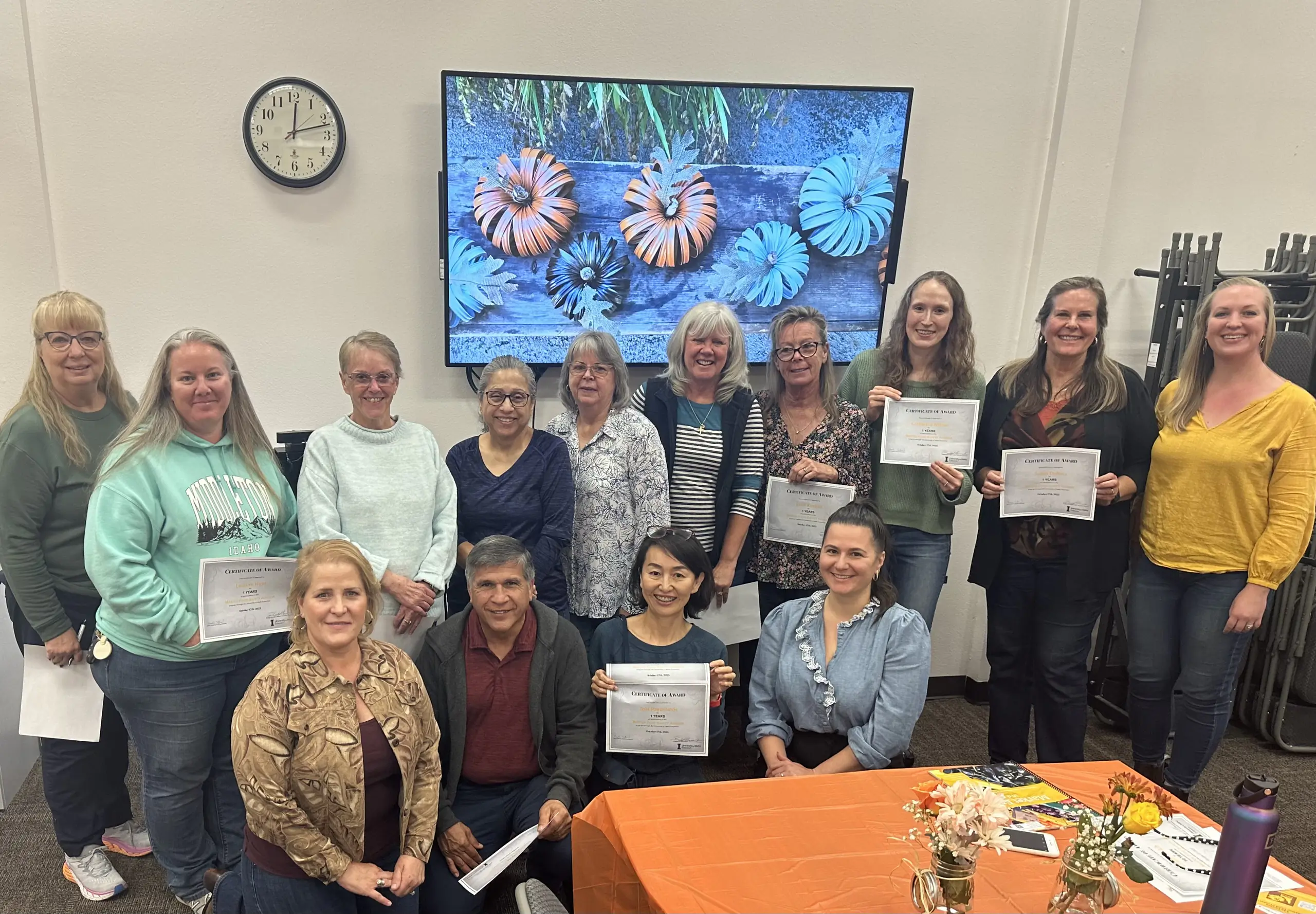 A group holding a certificate.