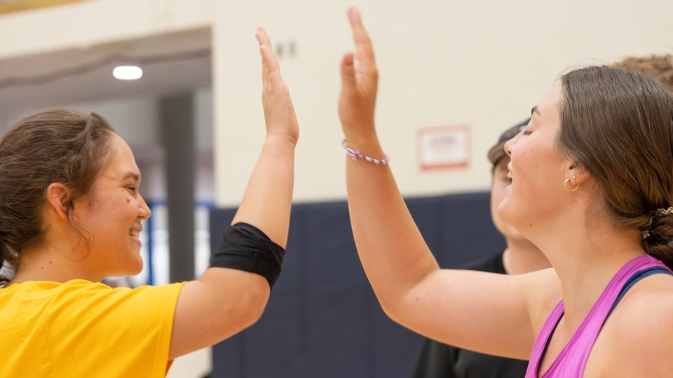 Two teammates high five.