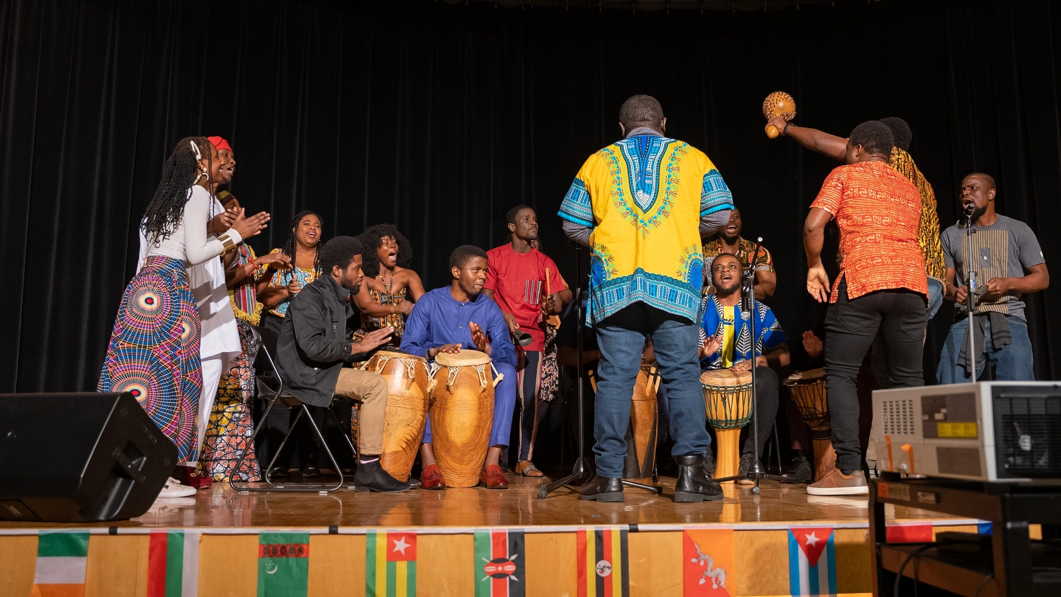 People perform music on stage with cultural attire
