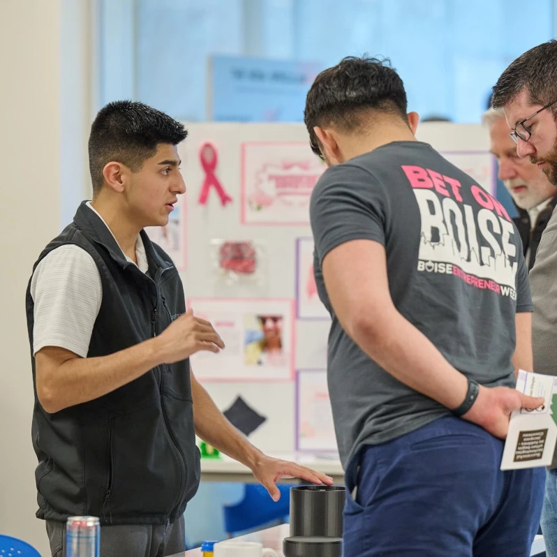 Ismael Valadez shows a device to several men