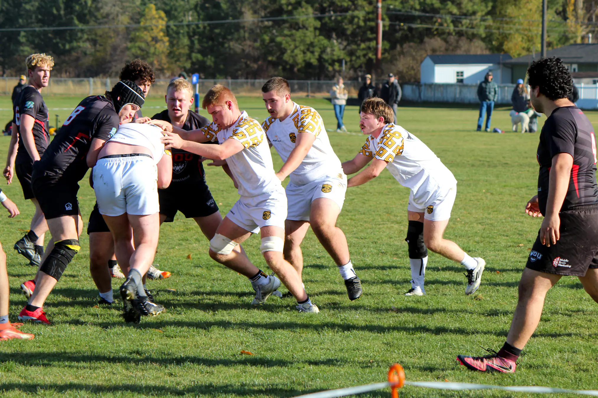 Action shot of the men's rugby club in a tackle during a match.