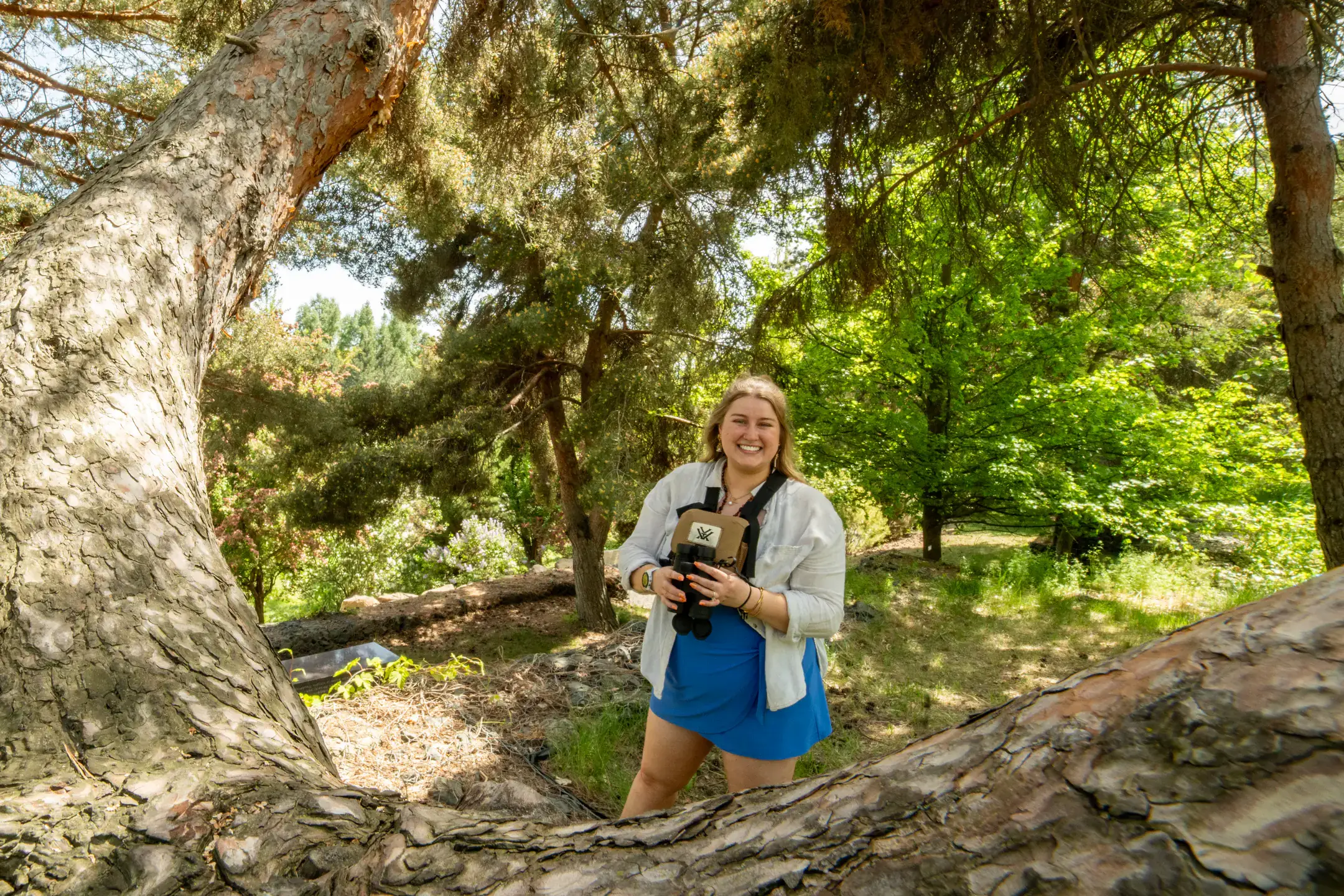 Lexi Arritt is pictured at the University of Idaho Arboretum and Botanical Garden on Tuesday, May 12, 2026. Arritt, who is graduating with a master’s degree in English, is a student in the Confluence Lab developing a narrative-based app and website designed to engage people with science, and primarily birds in Idaho. The Confluence Lab supports creative interdisciplinary research projects that bring together scholars in the arts, humanities and sciences with community members to address environmental issues impacting rural communities.