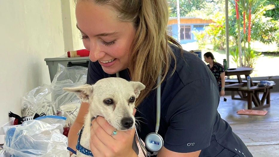 A woman holding a dog.