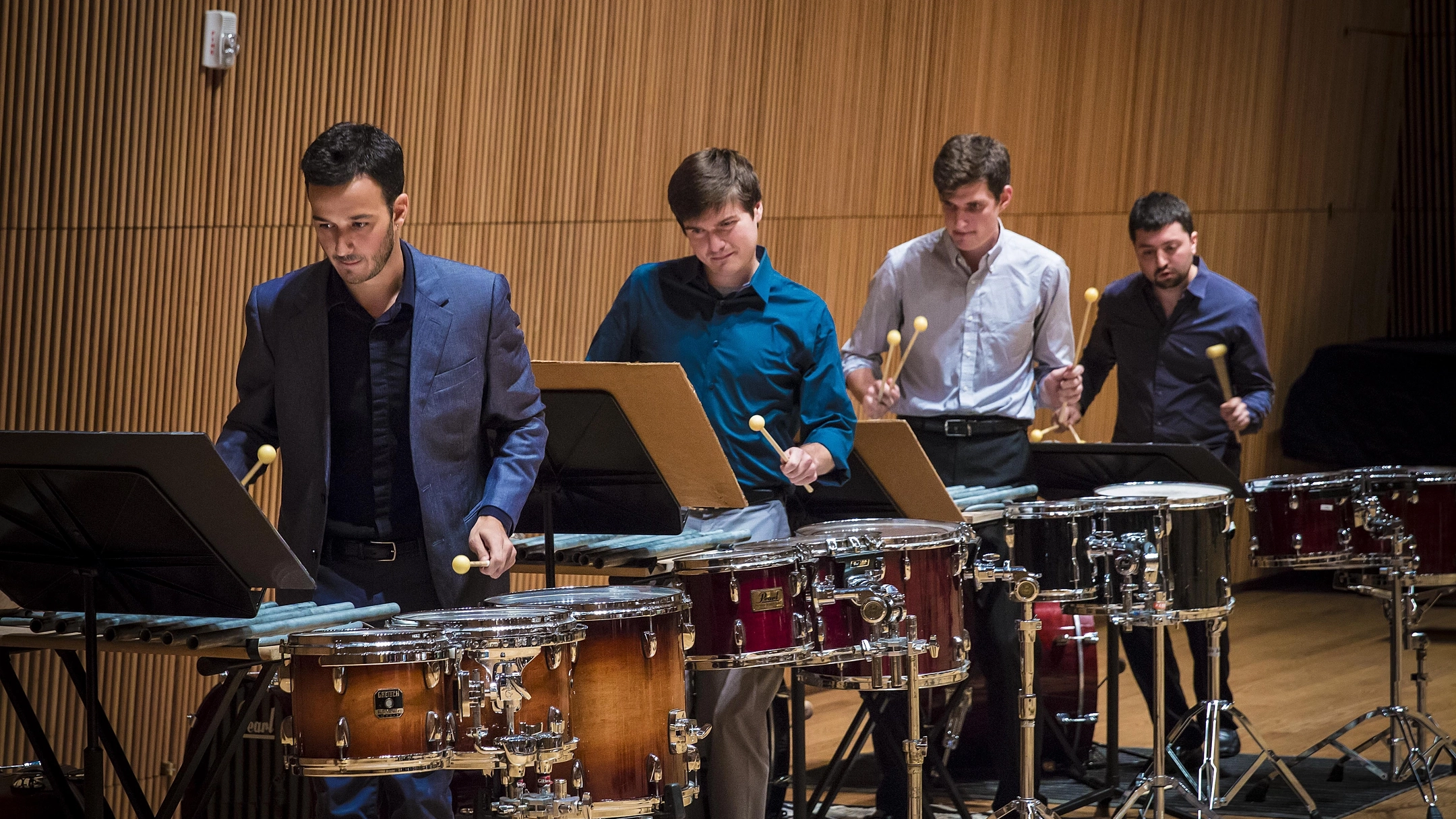 A percussion group of four men playing their instruments