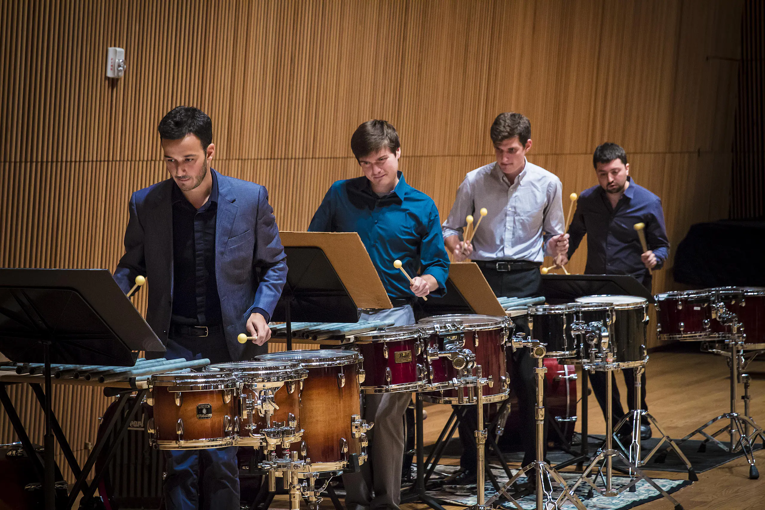 A percussion group of four men playing their instruments