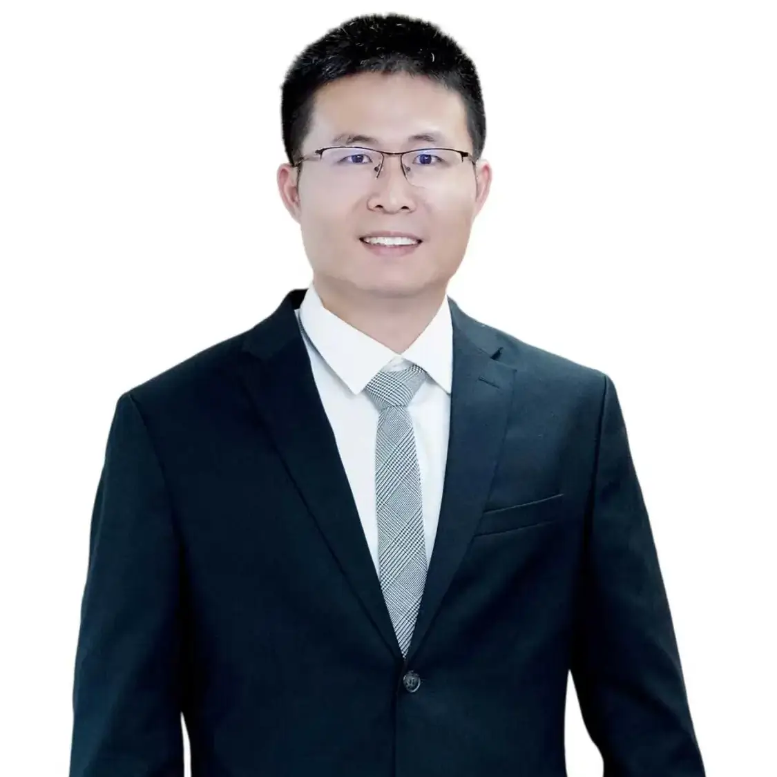 Professional headshot of a smiling man in glasses wearing a dark suit and light tie on a white background