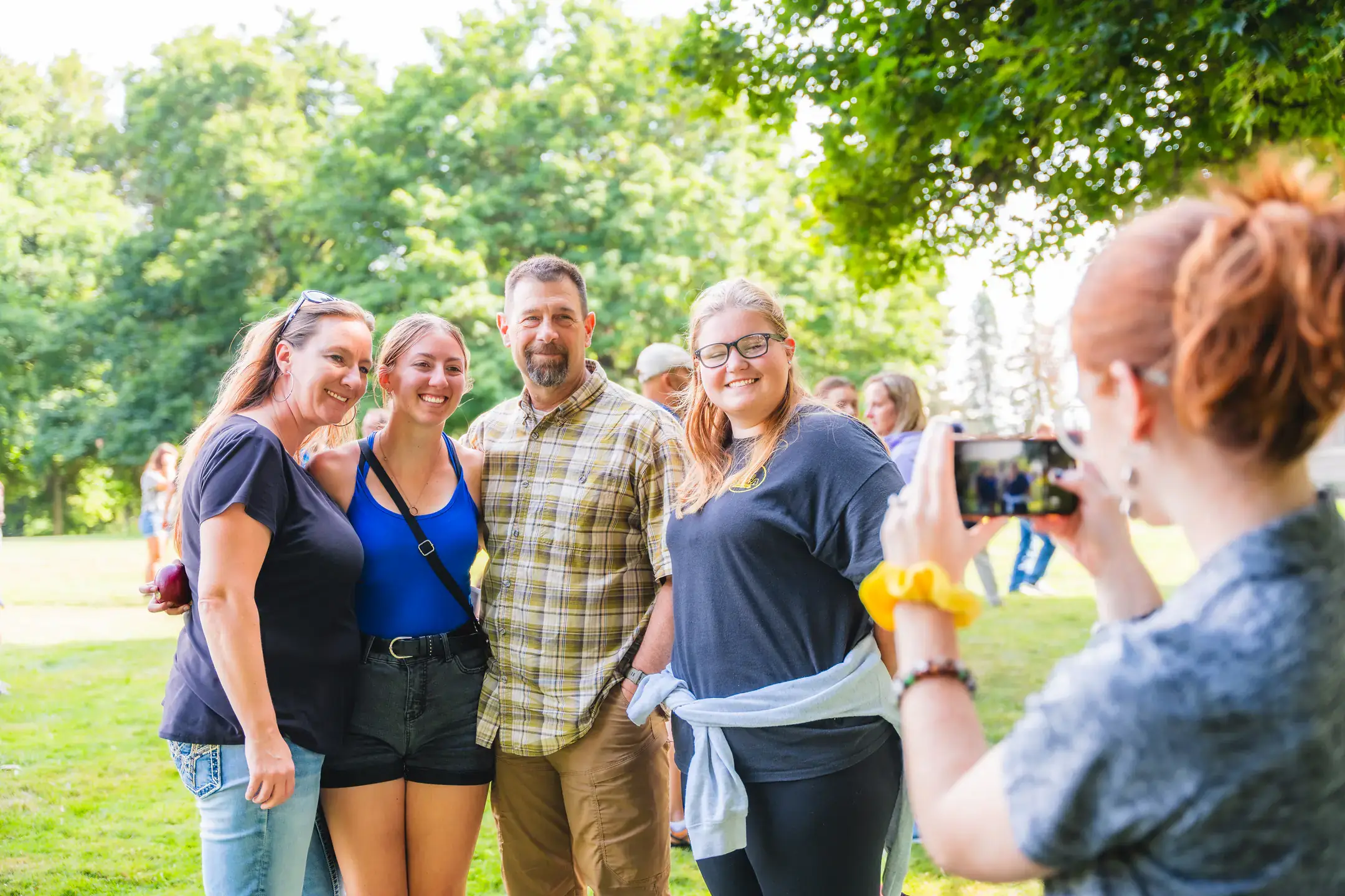 A family of four posing for a group photo on Move-In Day