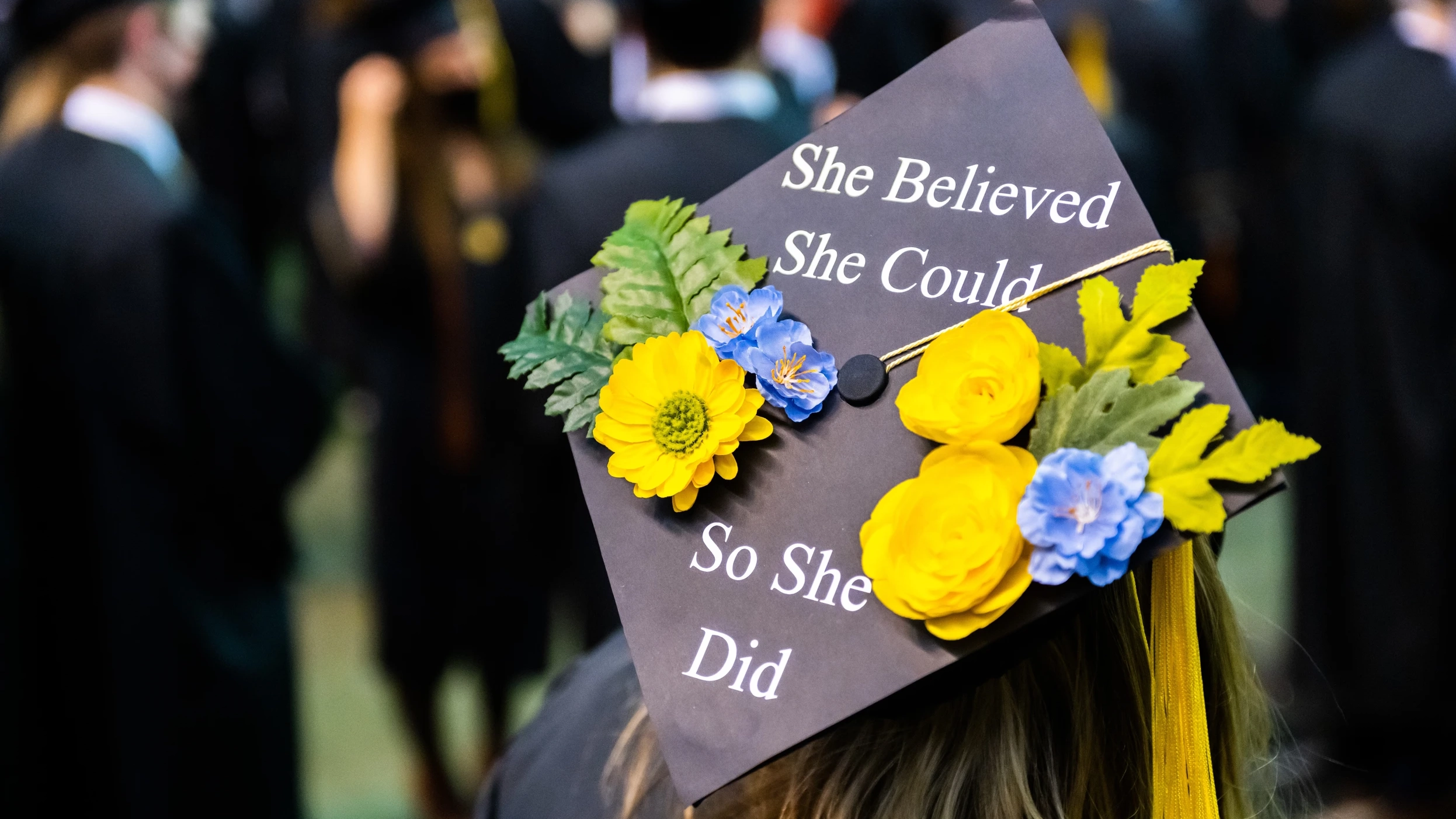 Photo of back of graduation cap at ceremony.
