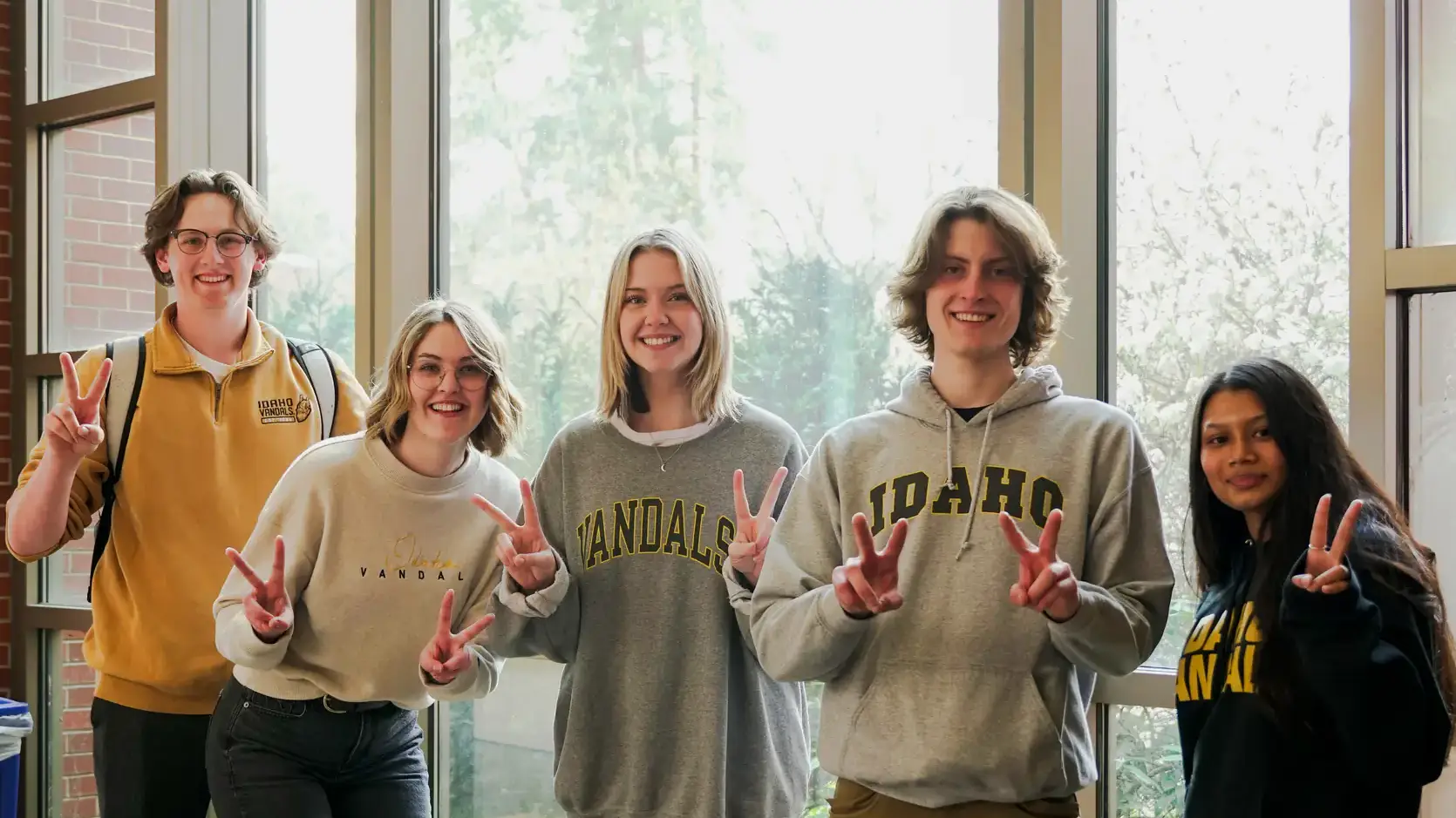 Students holding up "v's" with their fingers