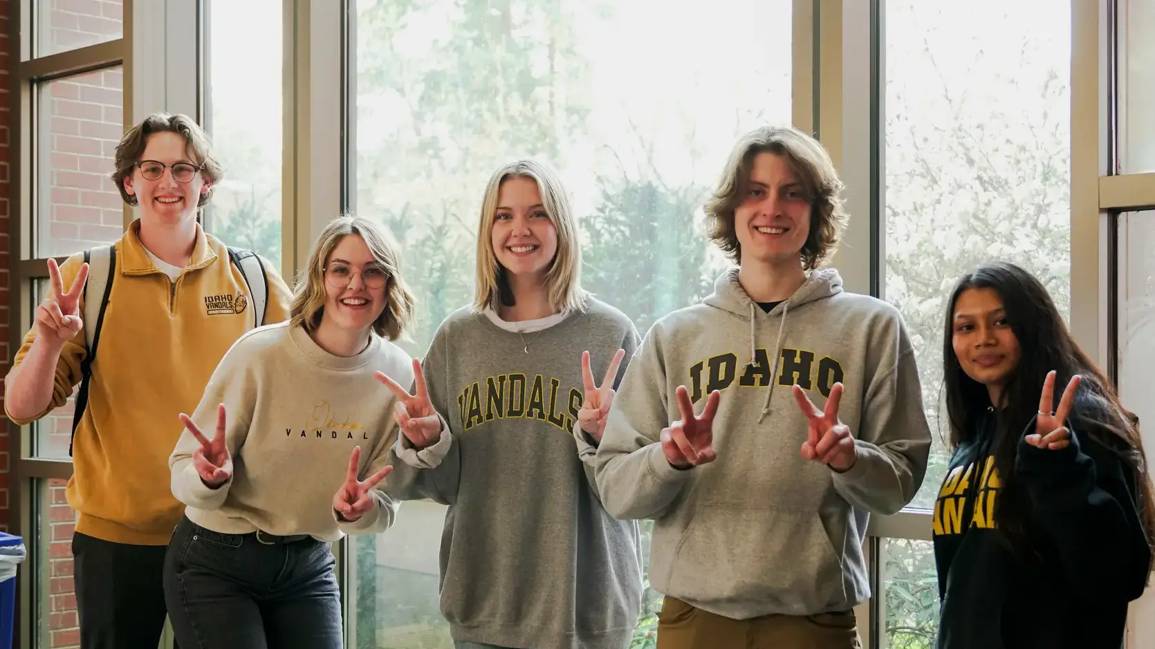 Students holding up "v's" with their fingers