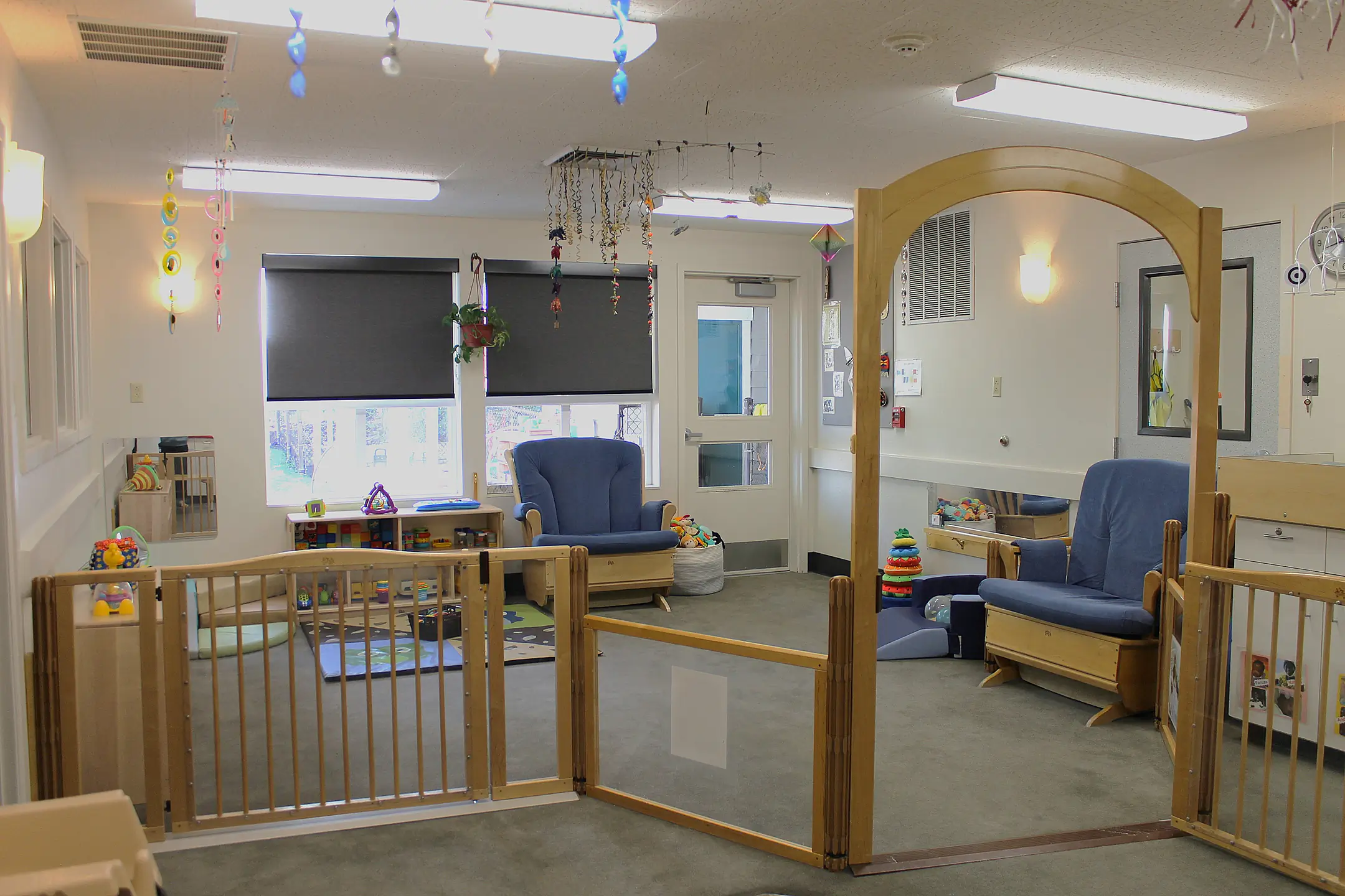 A gated indoor play area and rocking chairs.