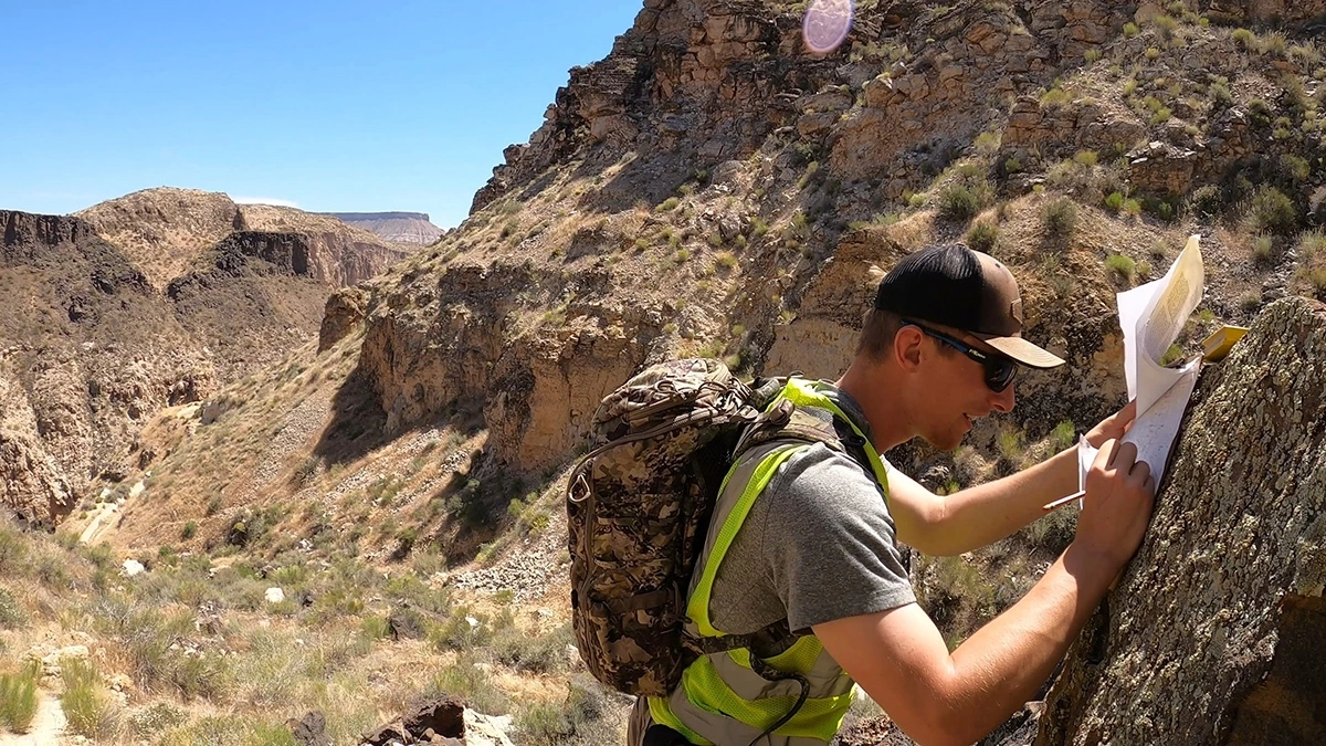 A student documents identified rock features while outdoors.