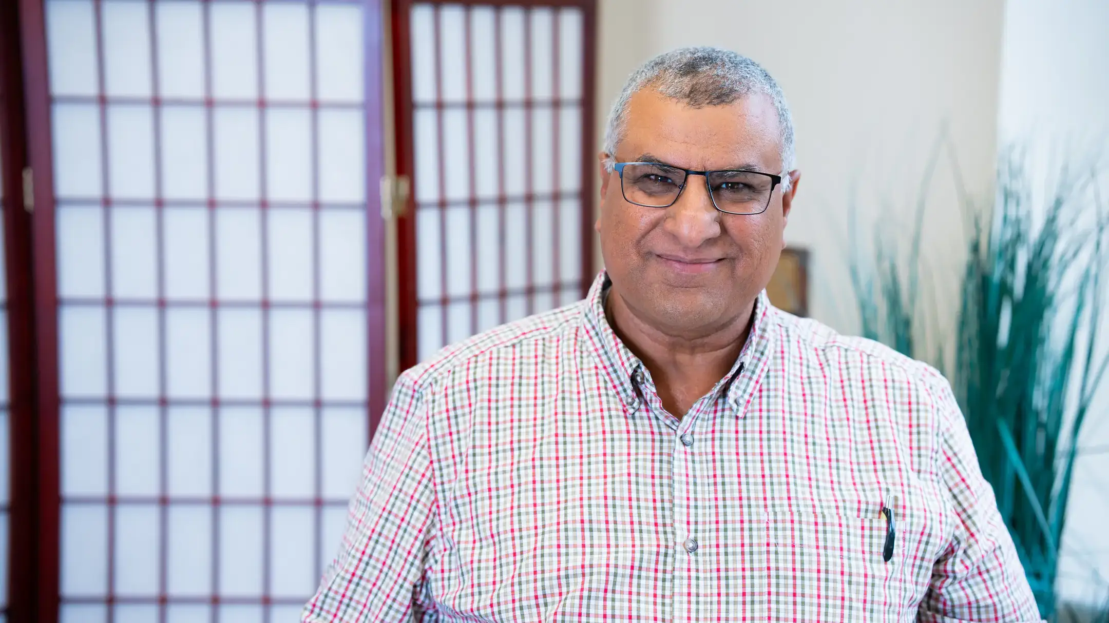 Hussain Qazaq poses for a studio photograph.