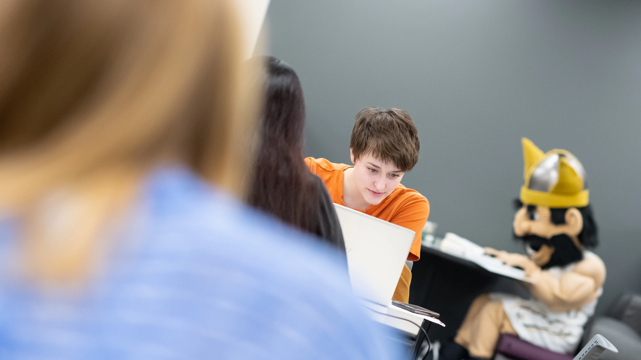 Students study for midterms with Joe Vandal in the background