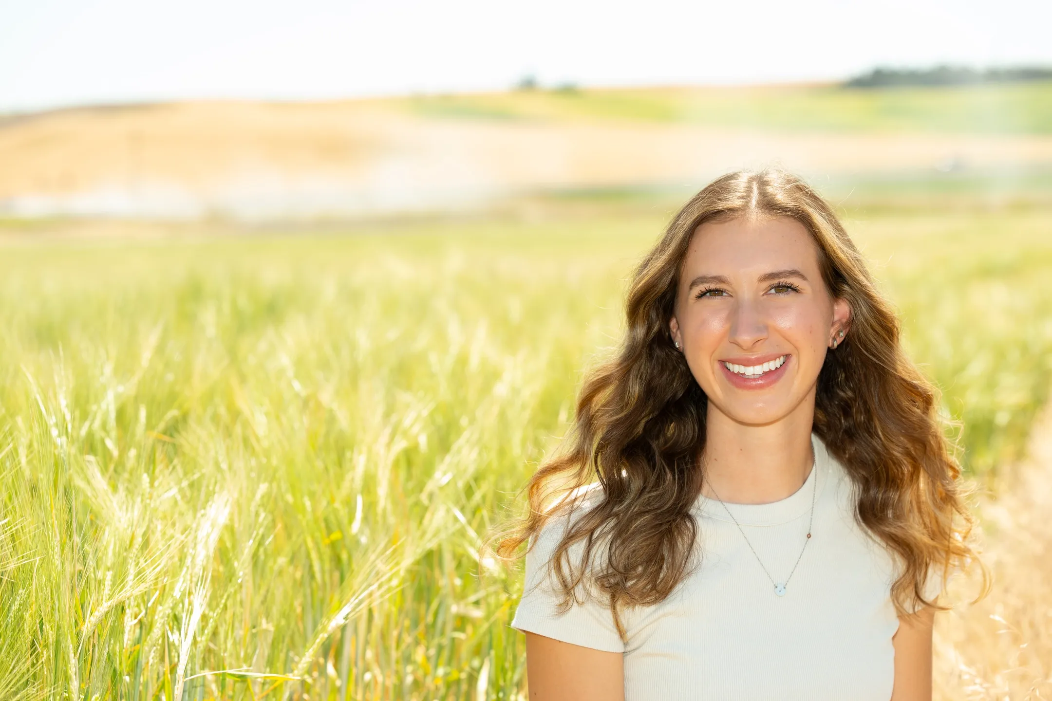 Student Jaycee Johnson is pictured in a barley field at Kambitsch Farm on May 28, 2025, where she and other students are doing Palouse Soil Moisture Project research.