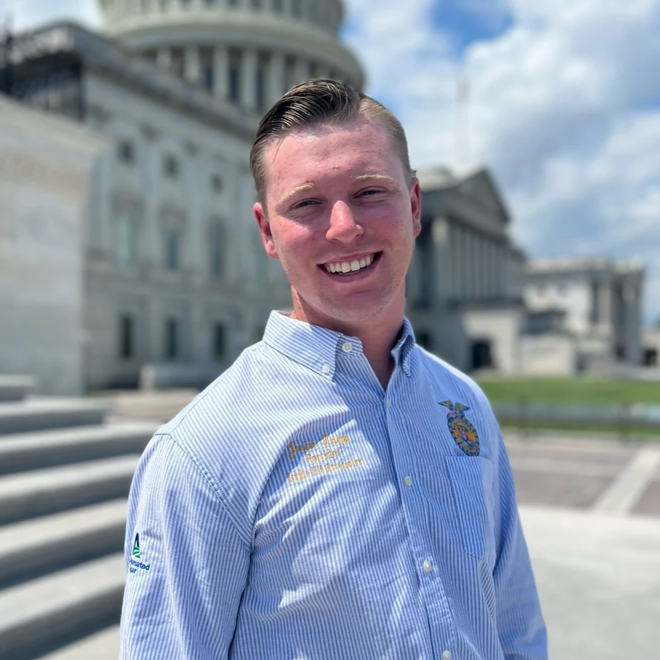 A man in front of the Boise capitol wearing an FFA shirt