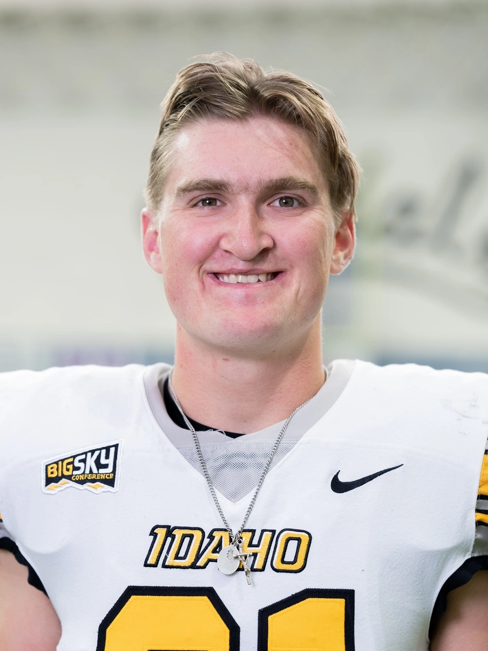 A smiling man in a football uniform