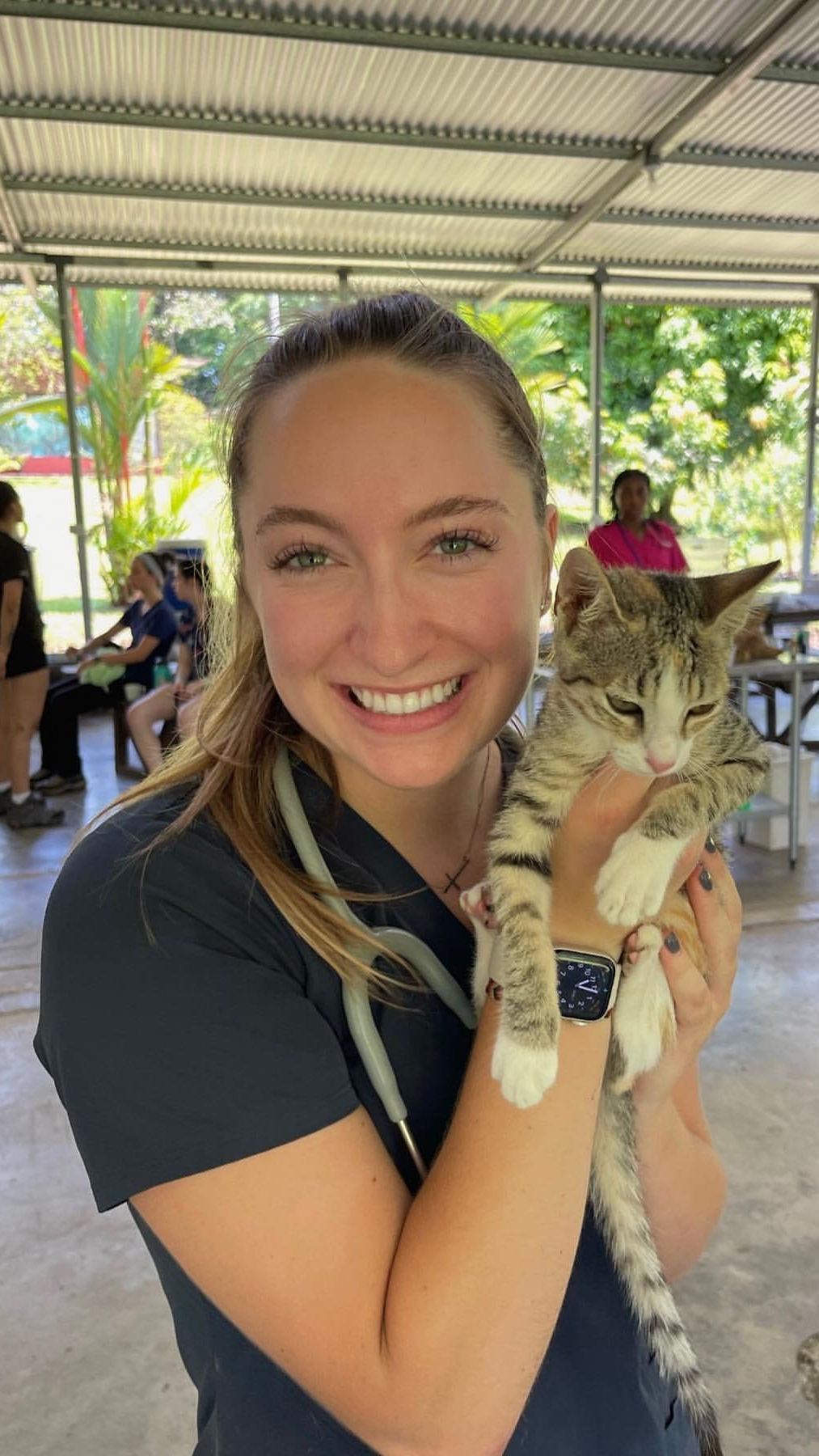 A woman holding a cat.