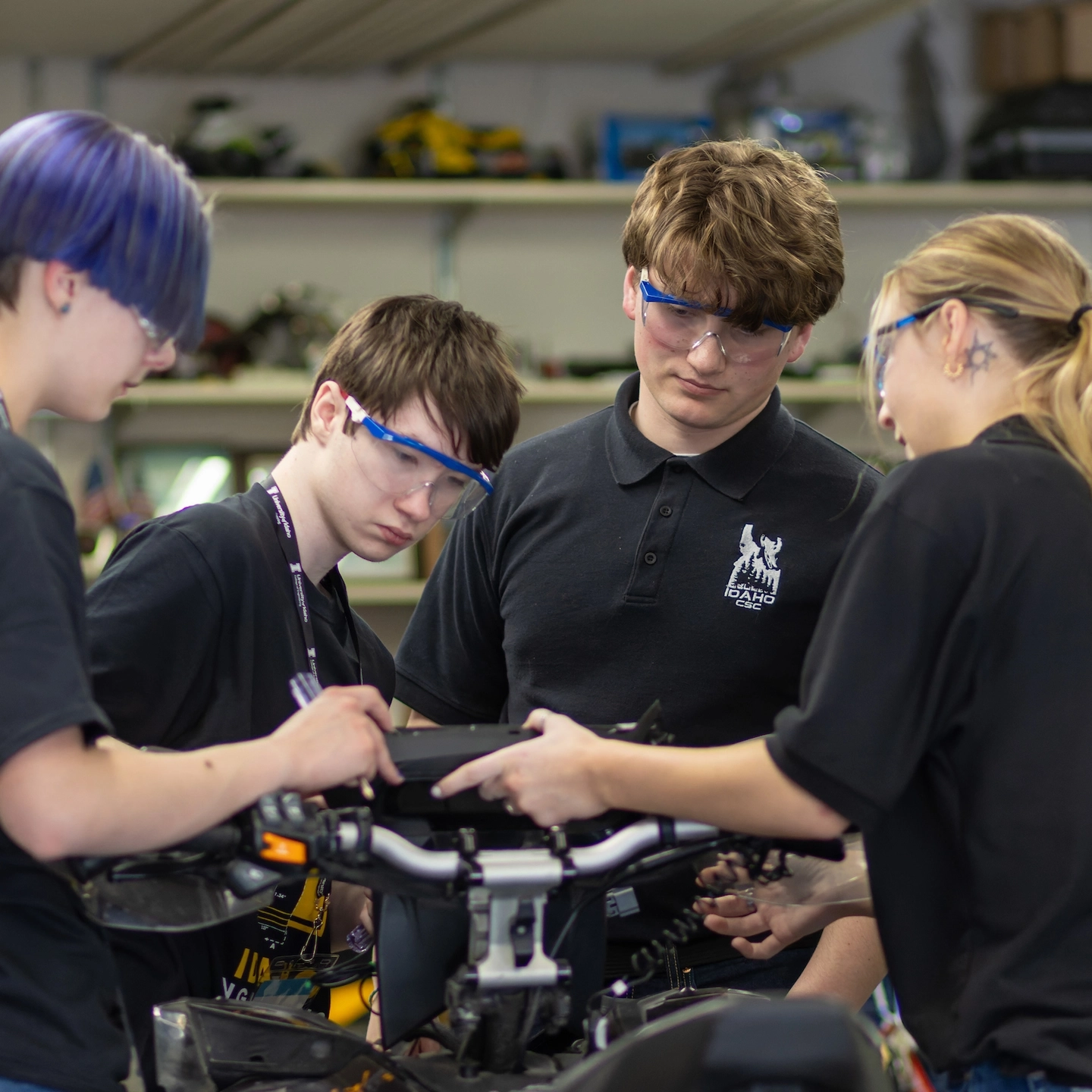 Students work together on a snowmobile