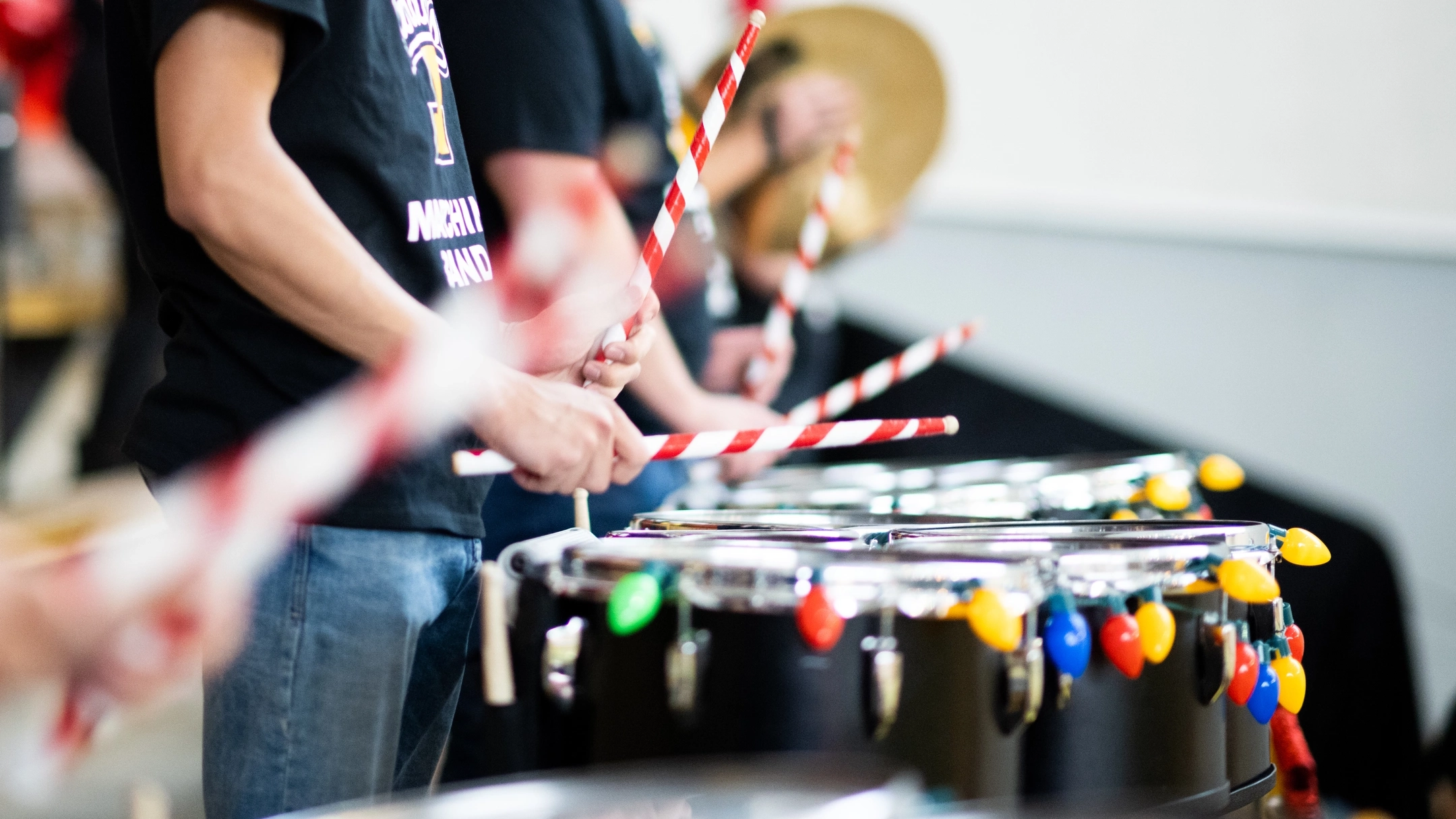 A band using candy cane inspired drumsticks during a performance