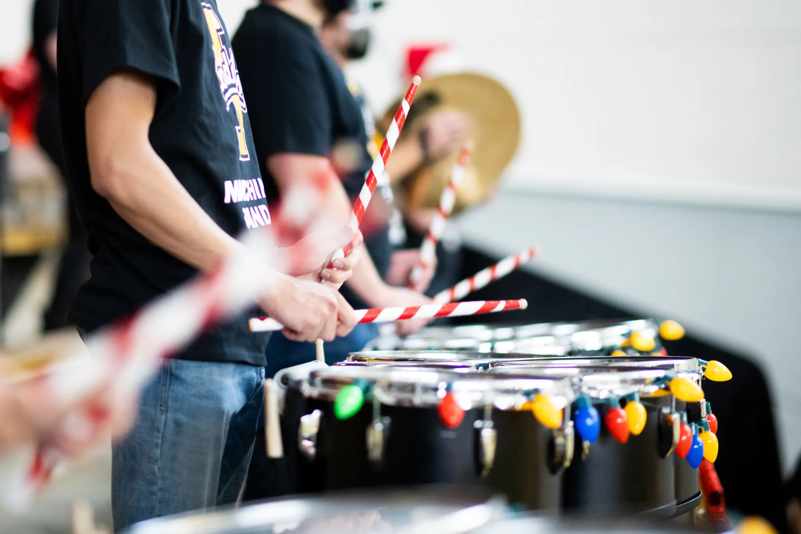 A band using candy cane inspired drumsticks during a performance