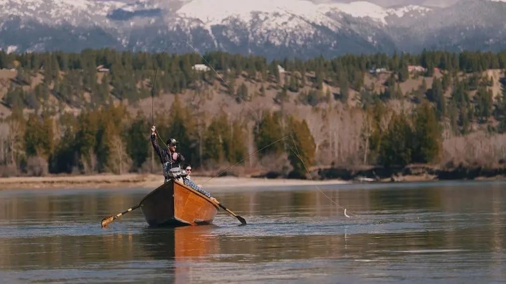A man in a paddle boat in a lake