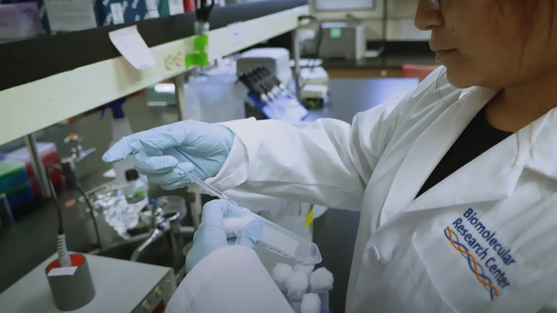 A woman in a lab coat doing an experiment