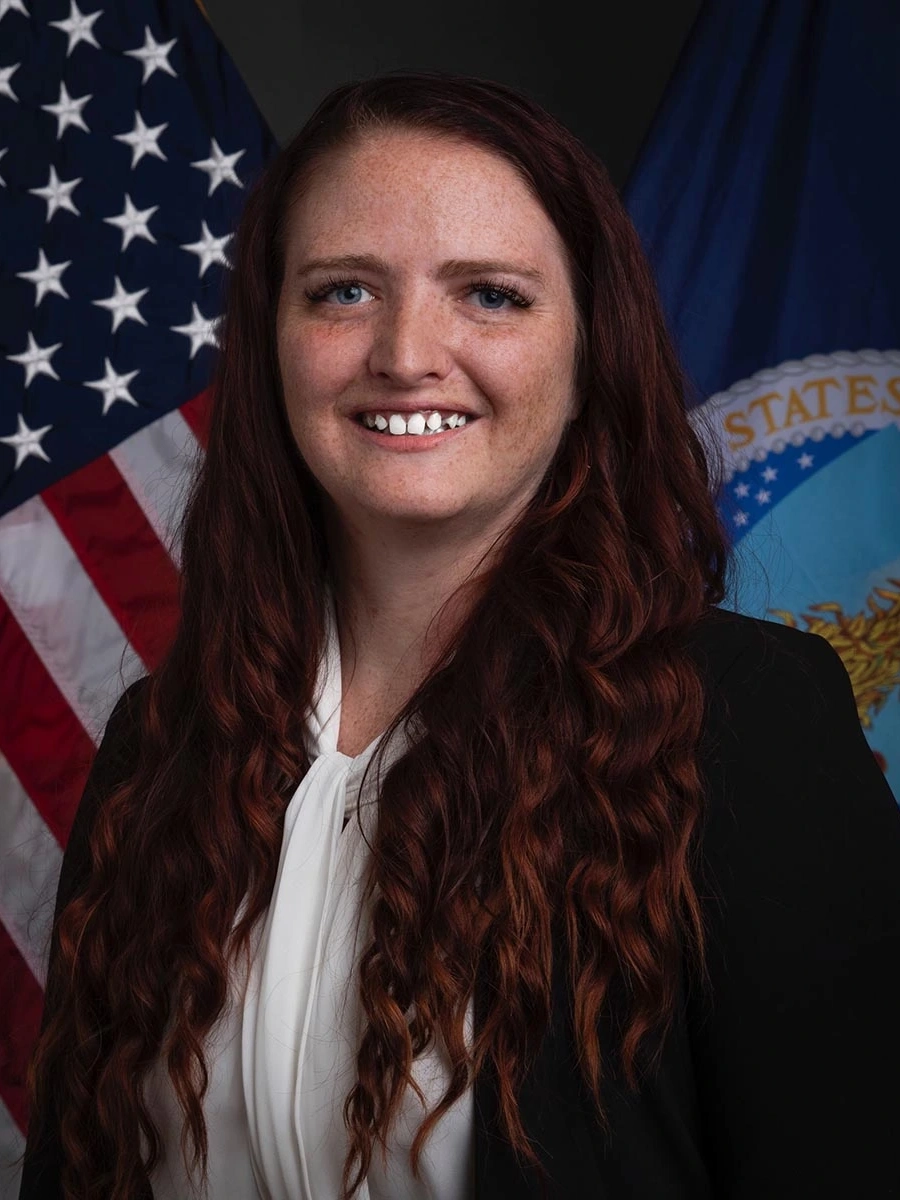 Portrait of woman in front of two flags