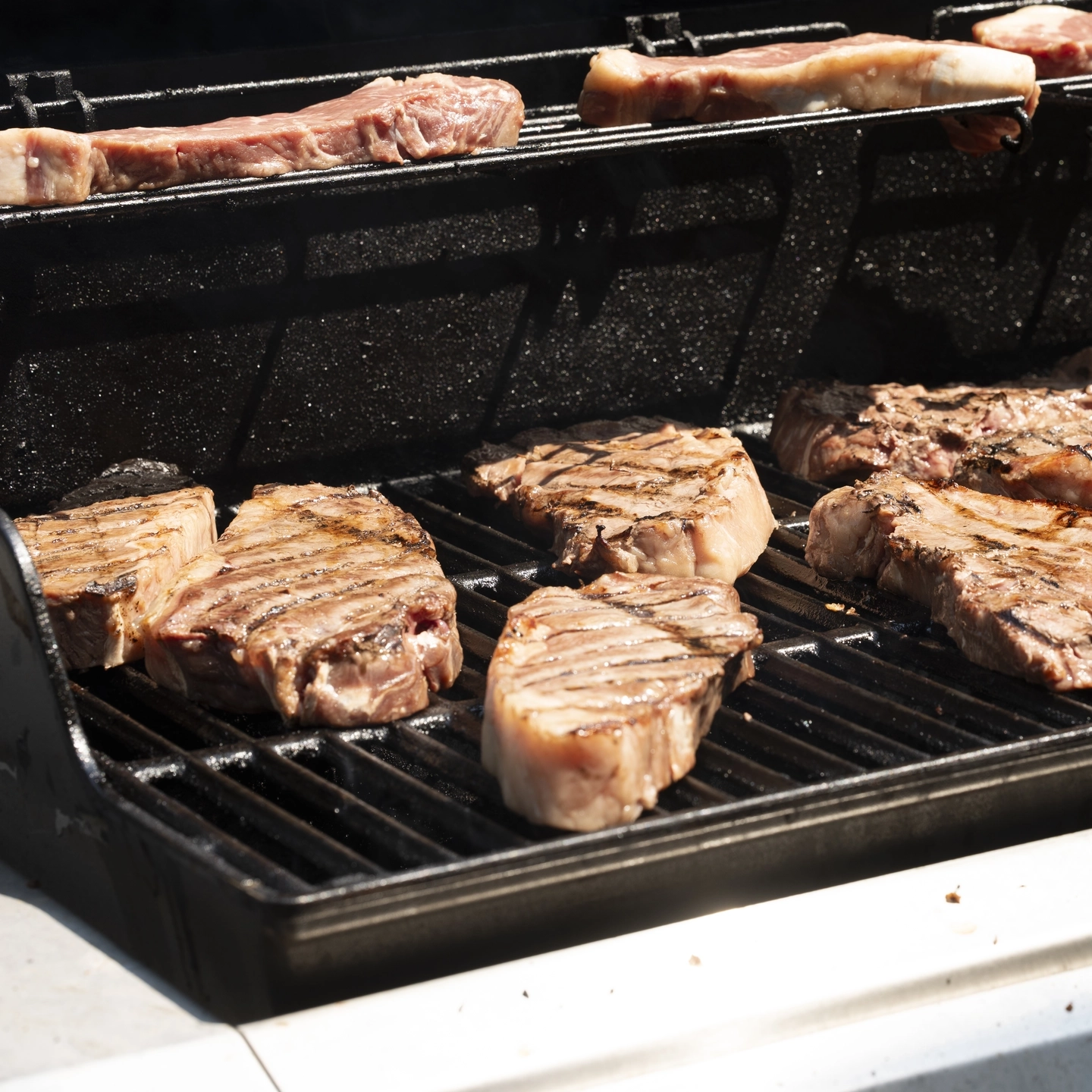 Various Vandal Brand Meat stakes and other meat products on a grill