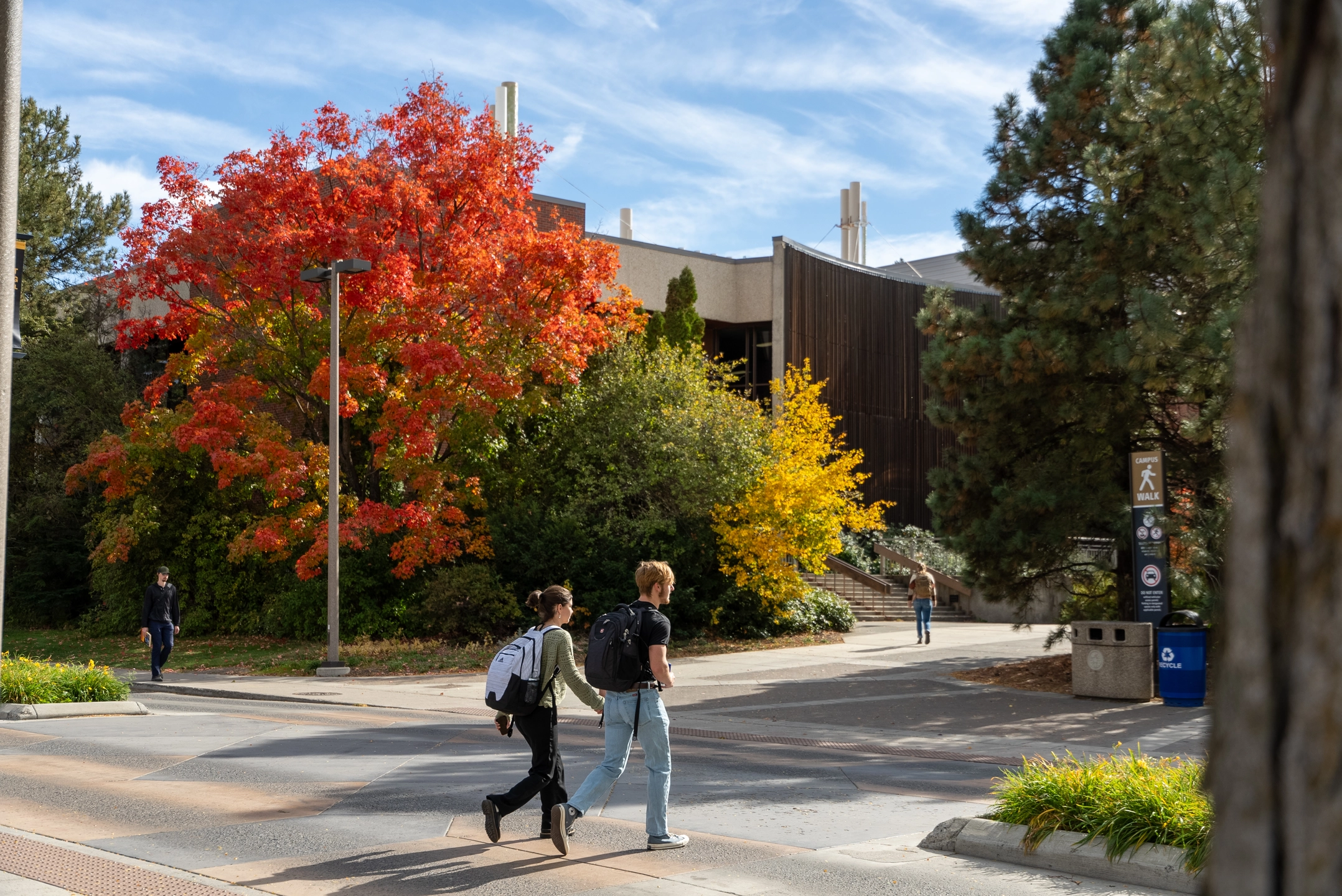 Two students walk past the western entrance to the College of Natural Resources building.