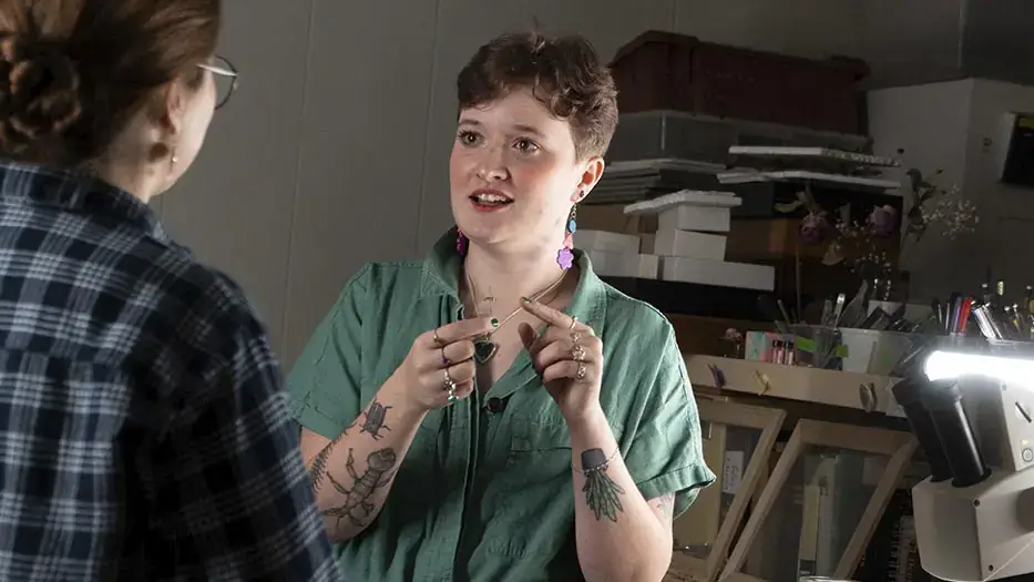 Two people deep in discussion next to a microscope.