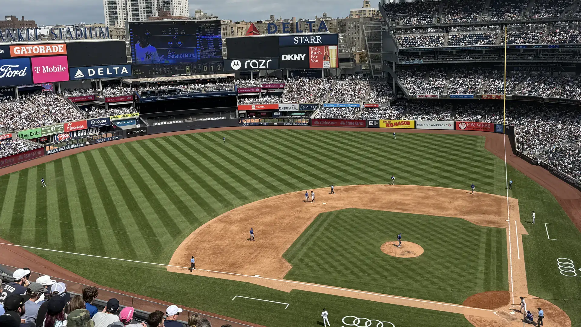 A baseball field with stadium seating packed full of people