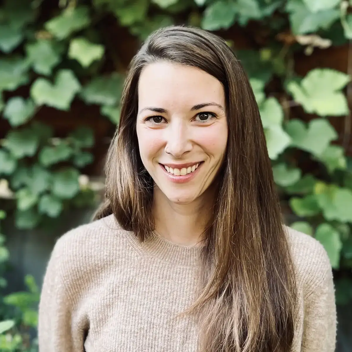 Laurel Lunch headshot standing in front of wall of ivy