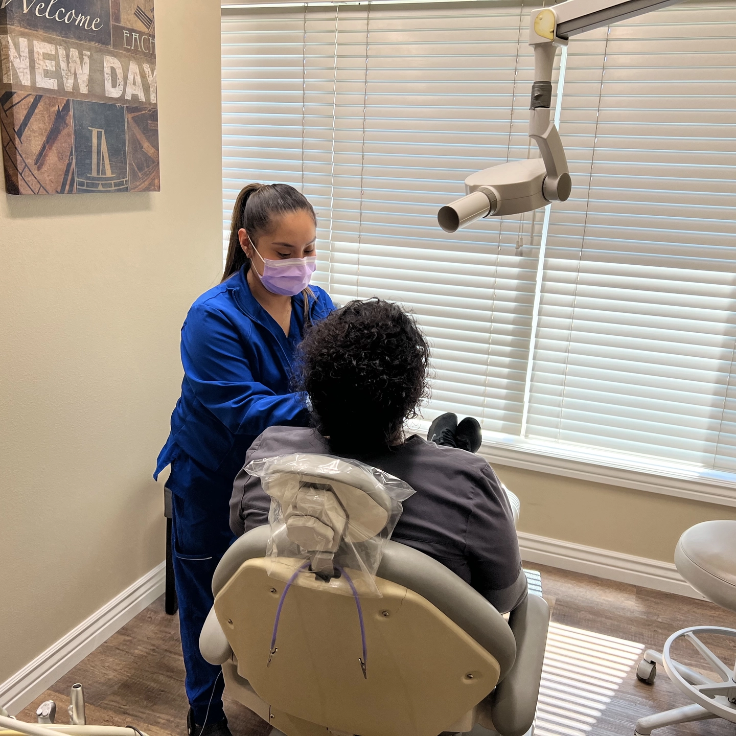 A woman taking dental films of a patient in a dentist office