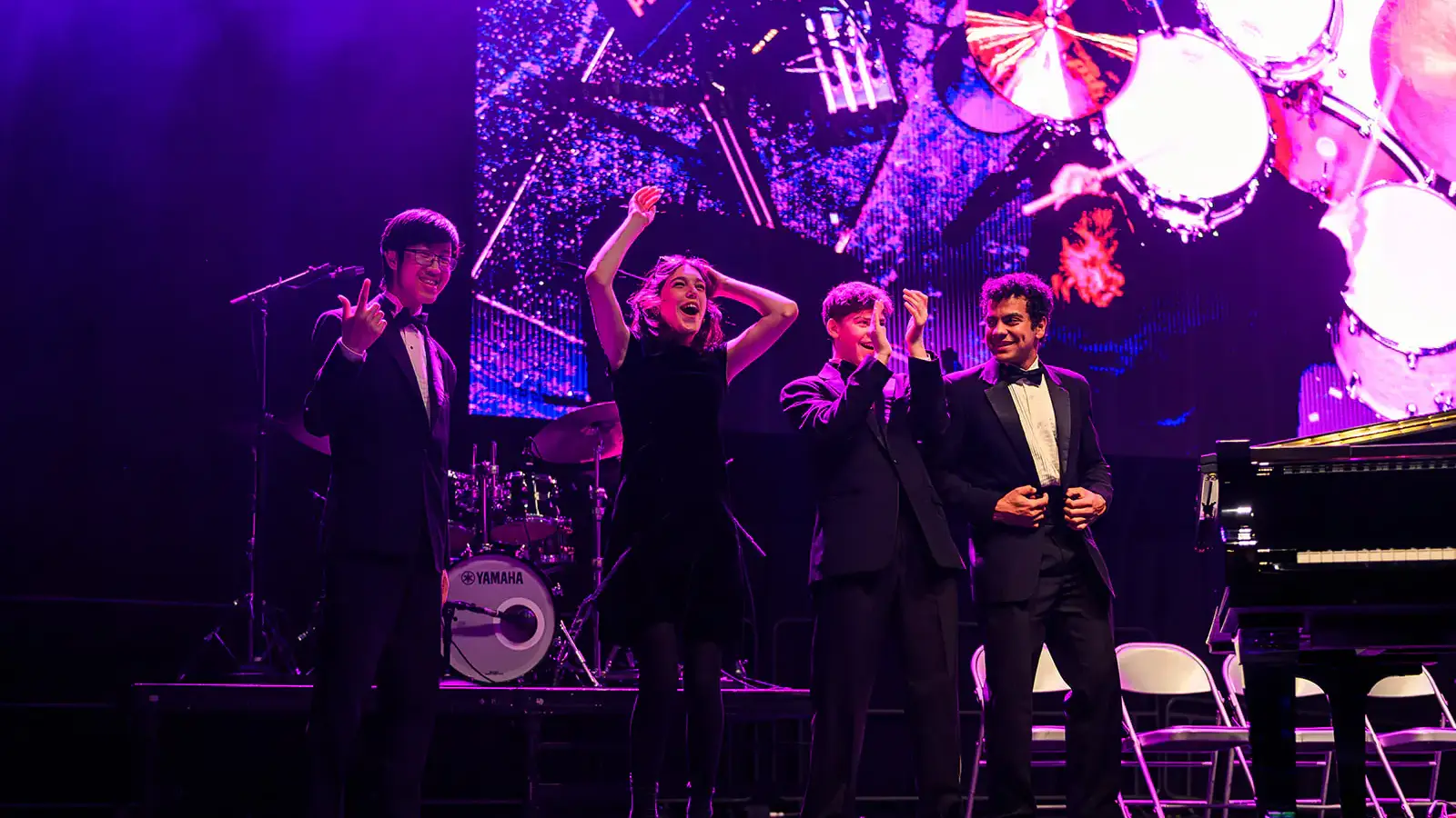 Four award winners on stage, celebrating